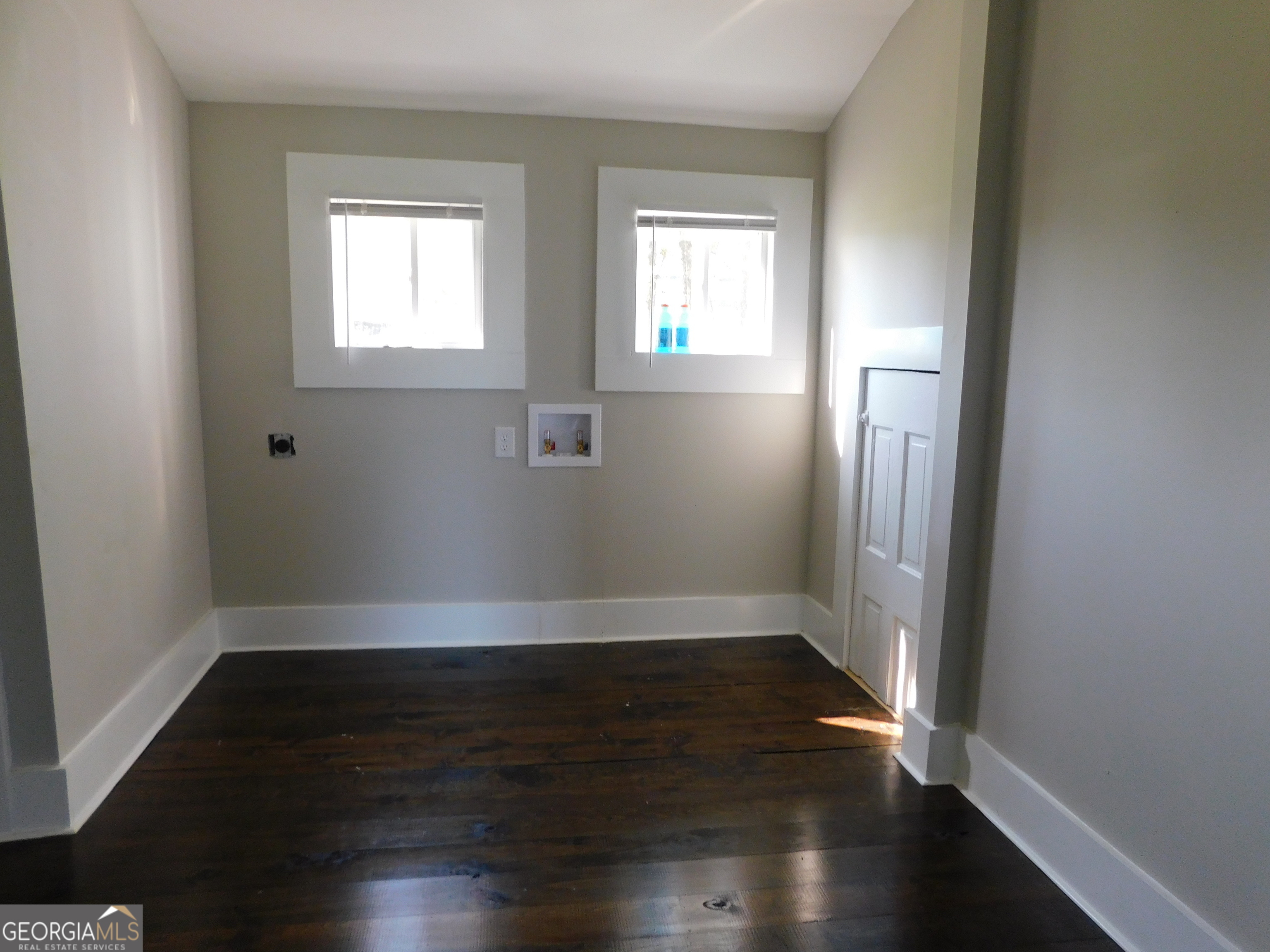 206 East Lane Street Brooklet, GA 30415 - Photo 25 of 33 an empty room with wooden floor and windows