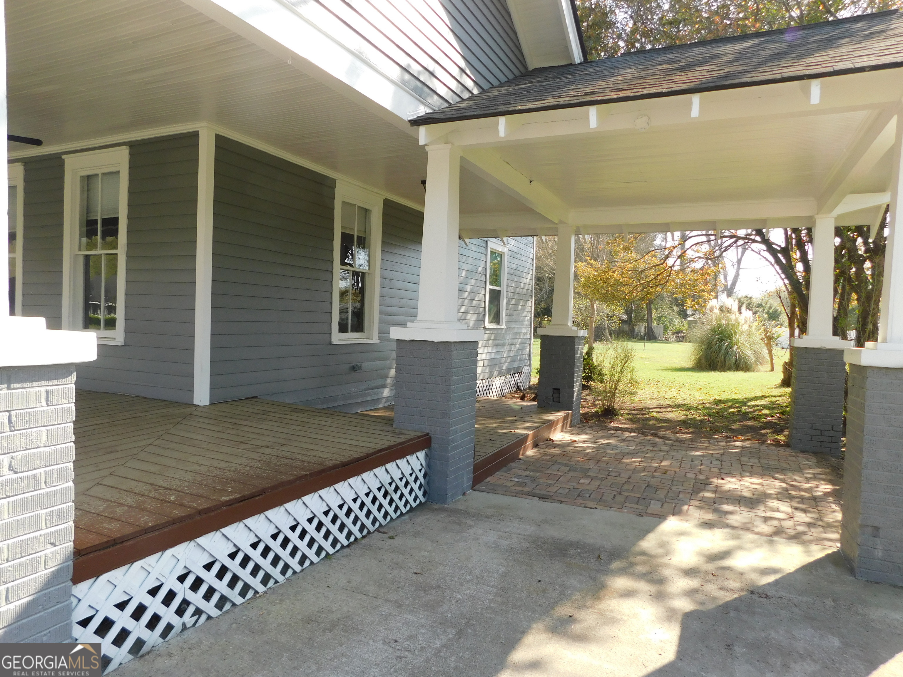 206 East Lane Street Brooklet, GA 30415 - Photo 3 of 33 a view of a porch with a wooden door