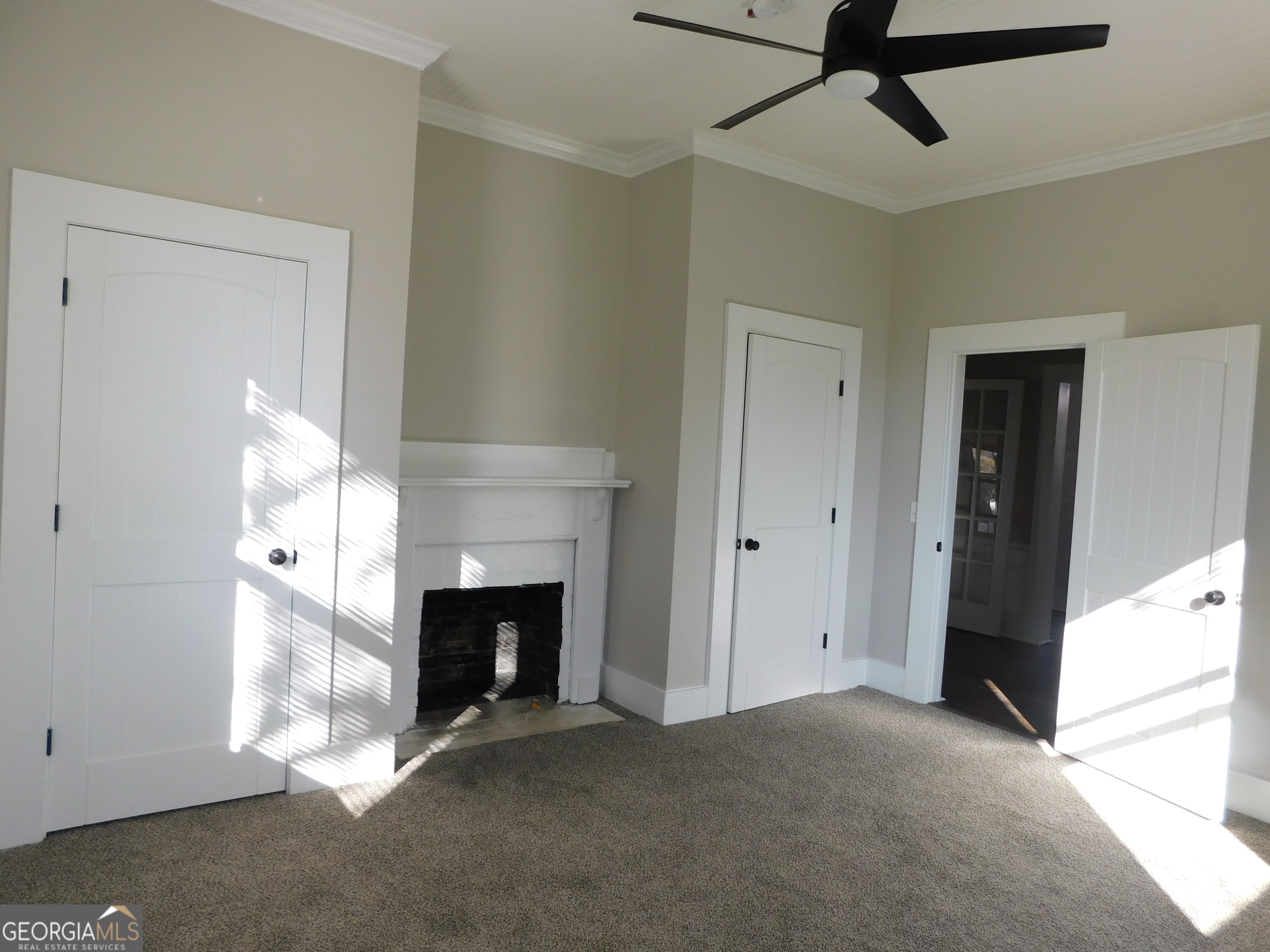 206 East Lane Street Brooklet, GA 30415 - Photo 6 of 33 a view of empty room with fireplace and fan
