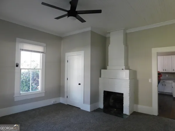 a view of a livingroom with a fireplace and window