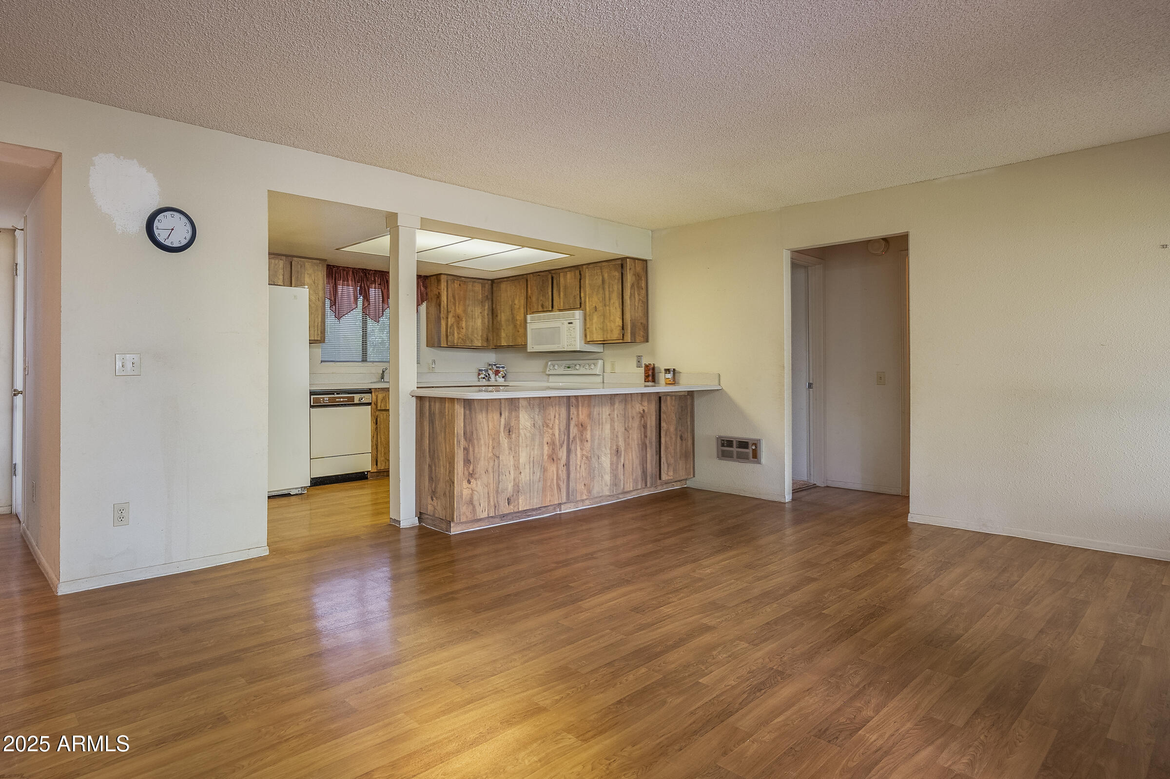 17980 Walapai Road, Unit 19A Munds Park, AZ 86017 - Photo 11 of 32 a view of a kitchen with wooden floor and electronic appliances
