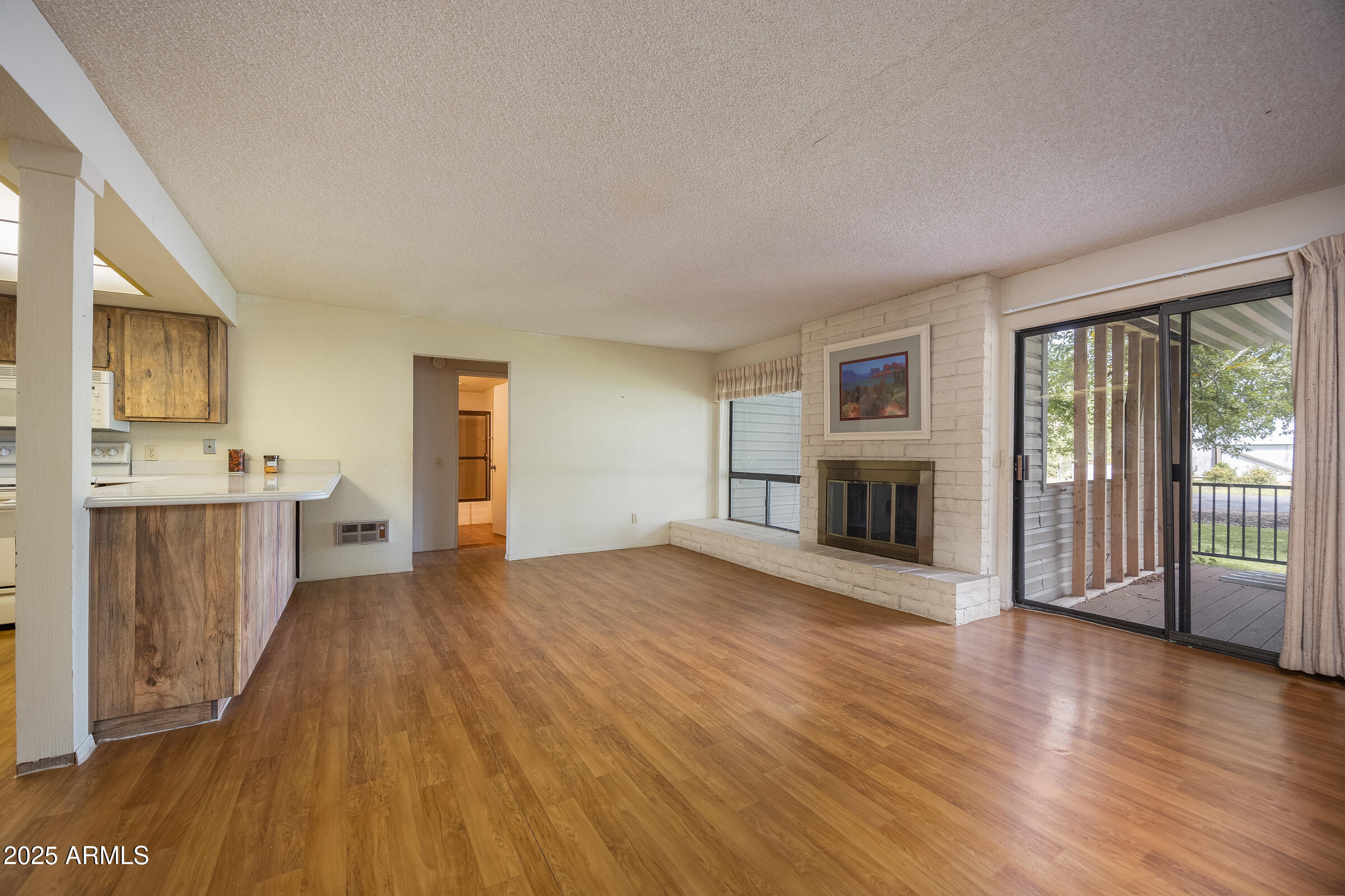 17980 Walapai Road, Unit 19A Munds Park, AZ 86017 - Photo 10 of 32 a view of a living room hardwood floor and a kitchen