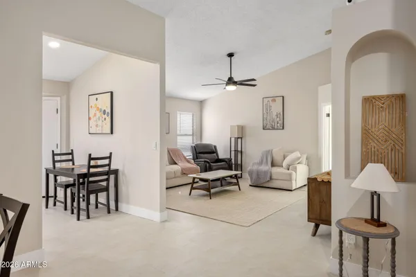 a living room with furniture and a lamp