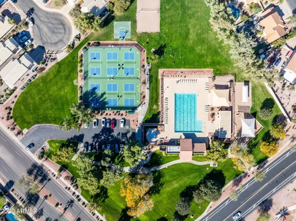 an aerial view of a residential apartment building with a yard and outdoor seating