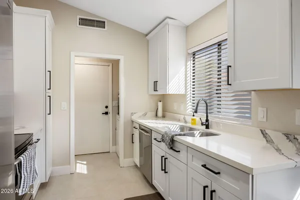 a kitchen with a sink stove and cabinets