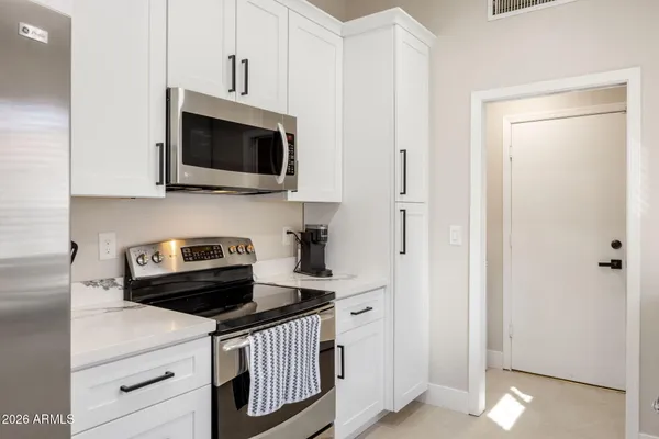 a kitchen with stainless steel appliances a stove a microwave and cabinets