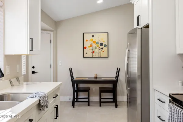 a view of a kitchen area with furniture and wooden floor