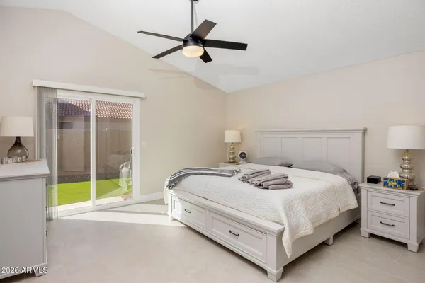 a bedroom with a bed a couch and a window