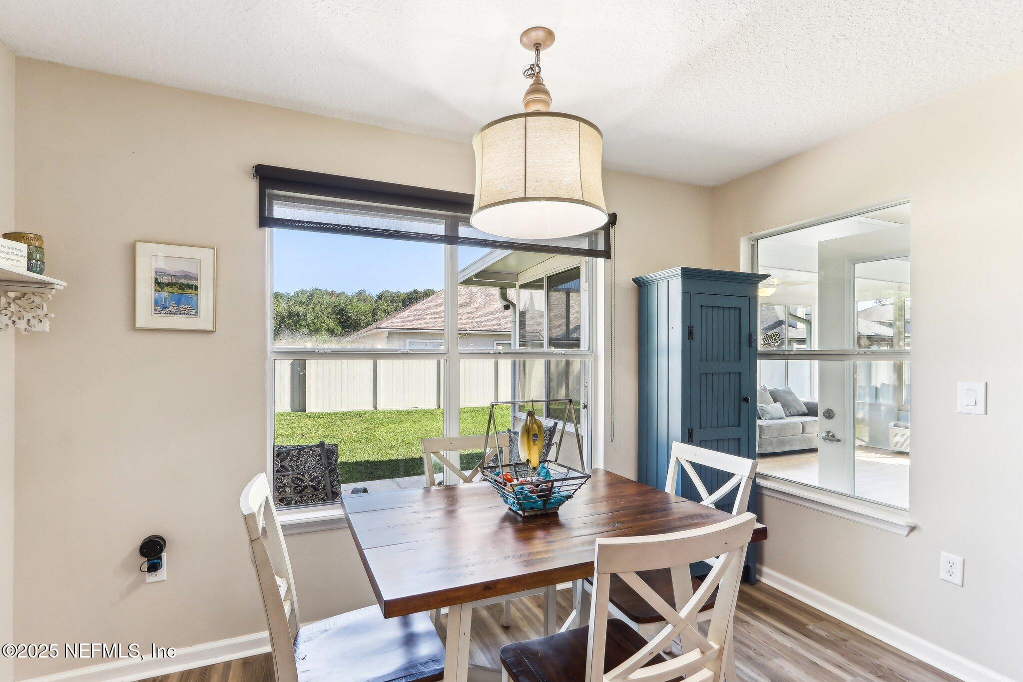 2124 Pond Spring Way Fleming Island, FL 32003 - Photo 12 of 56 a view of a dining room with furniture window and outside view