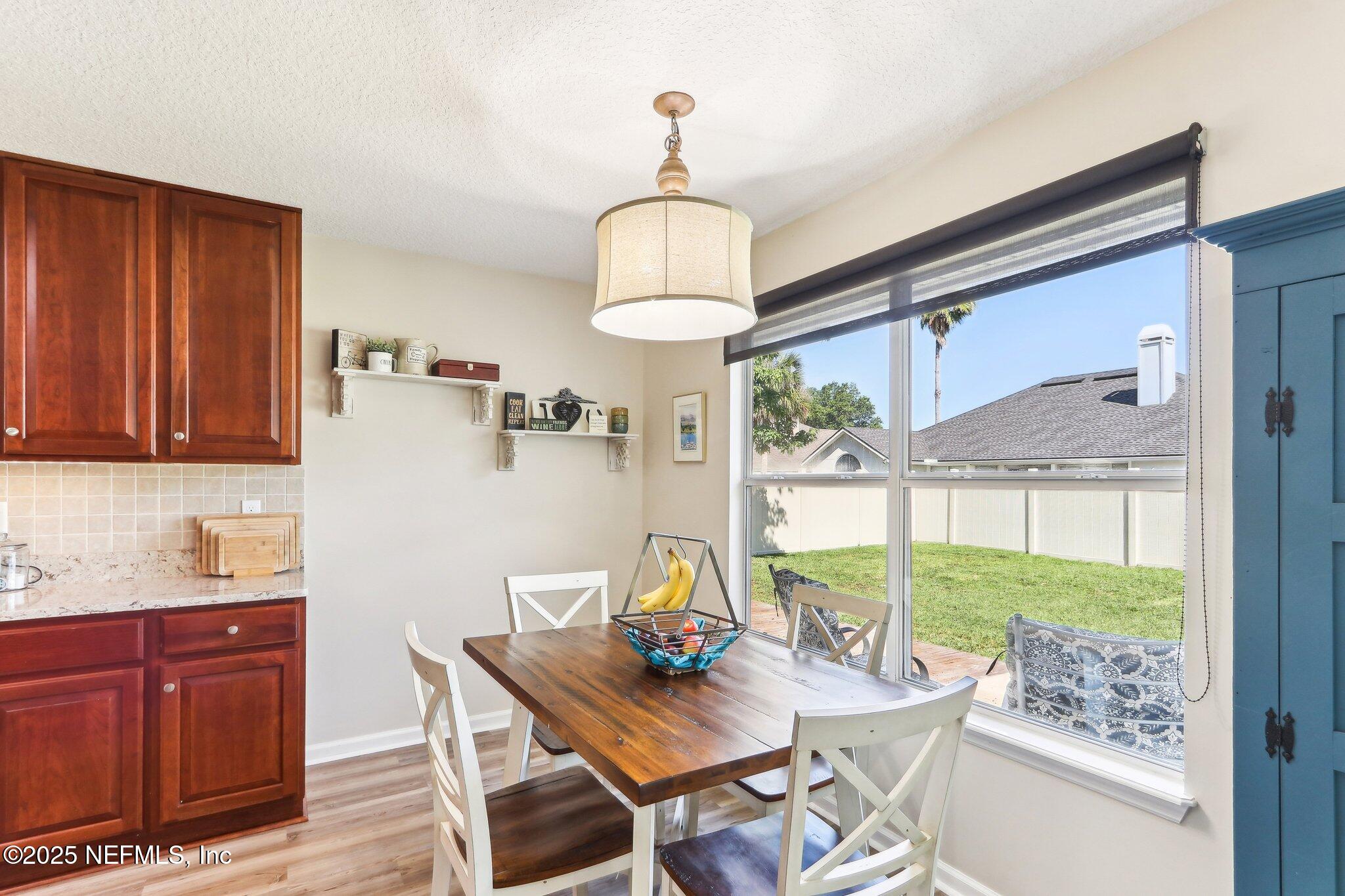 2124 Pond Spring Way Fleming Island, FL 32003 - Photo 13 of 56 a view of a dining room with furniture window and outside view