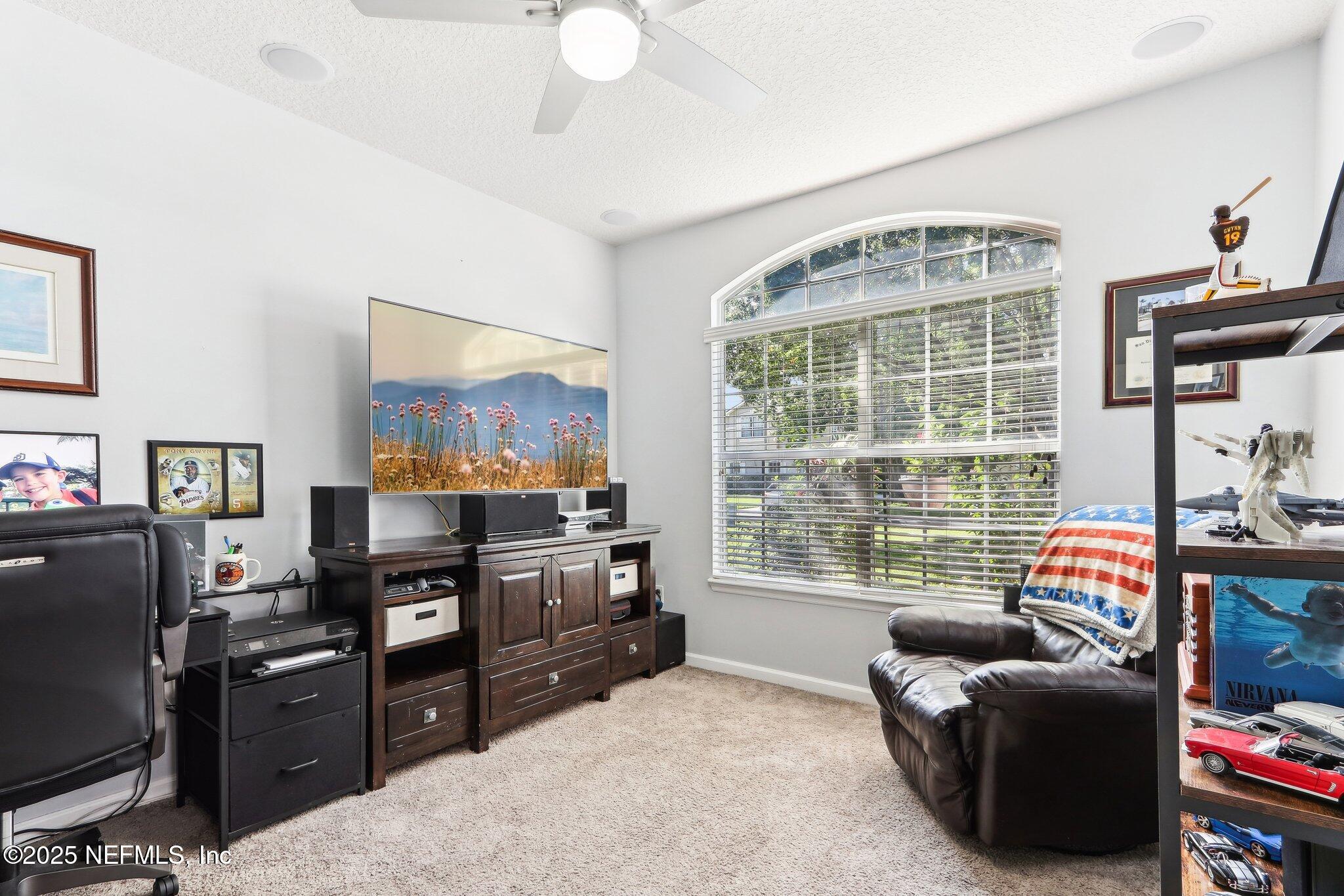 2124 Pond Spring Way Fleming Island, FL 32003 - Photo 20 of 56 a living room with furniture and a flat screen tv