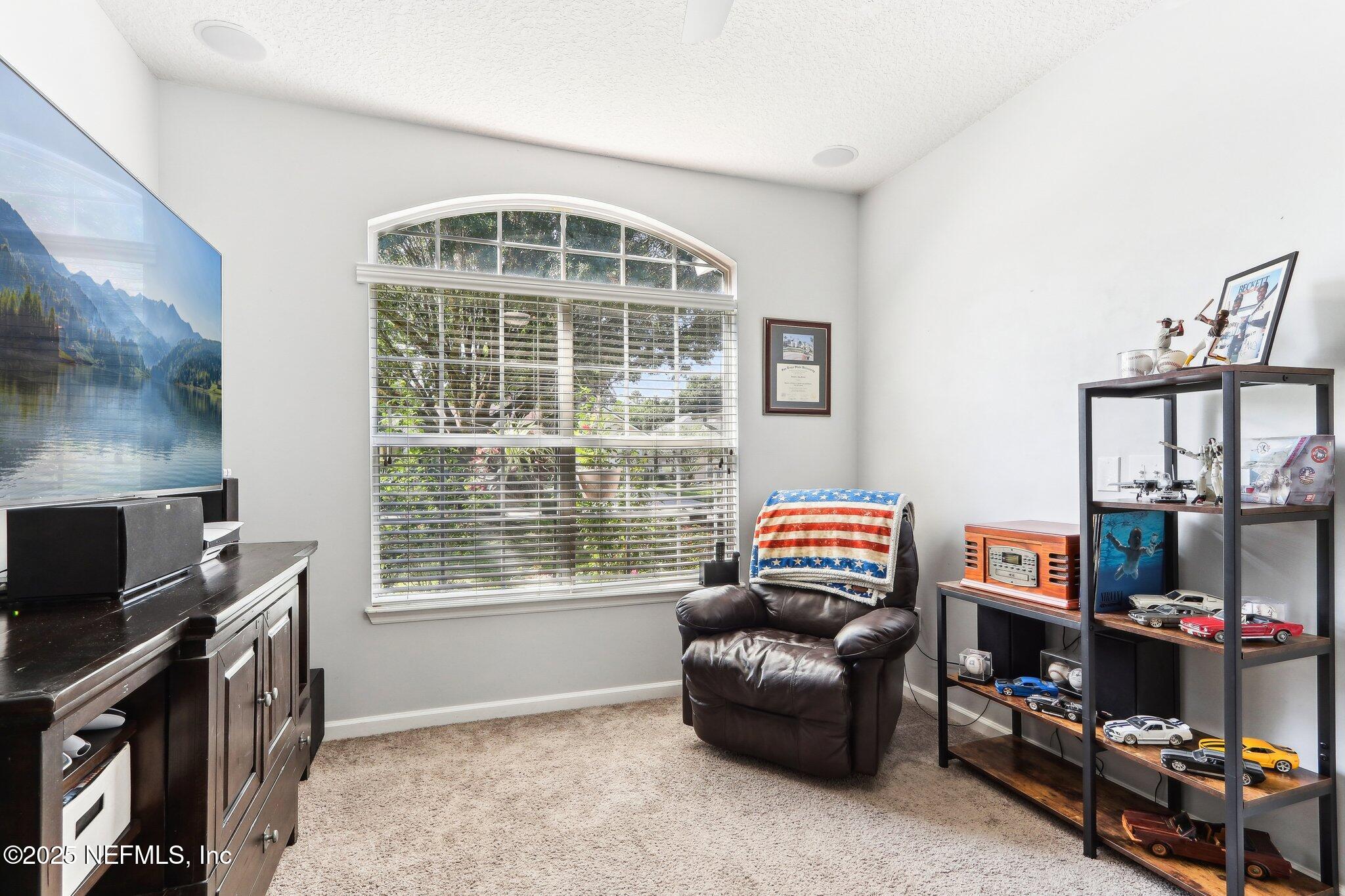 2124 Pond Spring Way Fleming Island, FL 32003 - Photo 21 of 56 a living room with furniture and a window