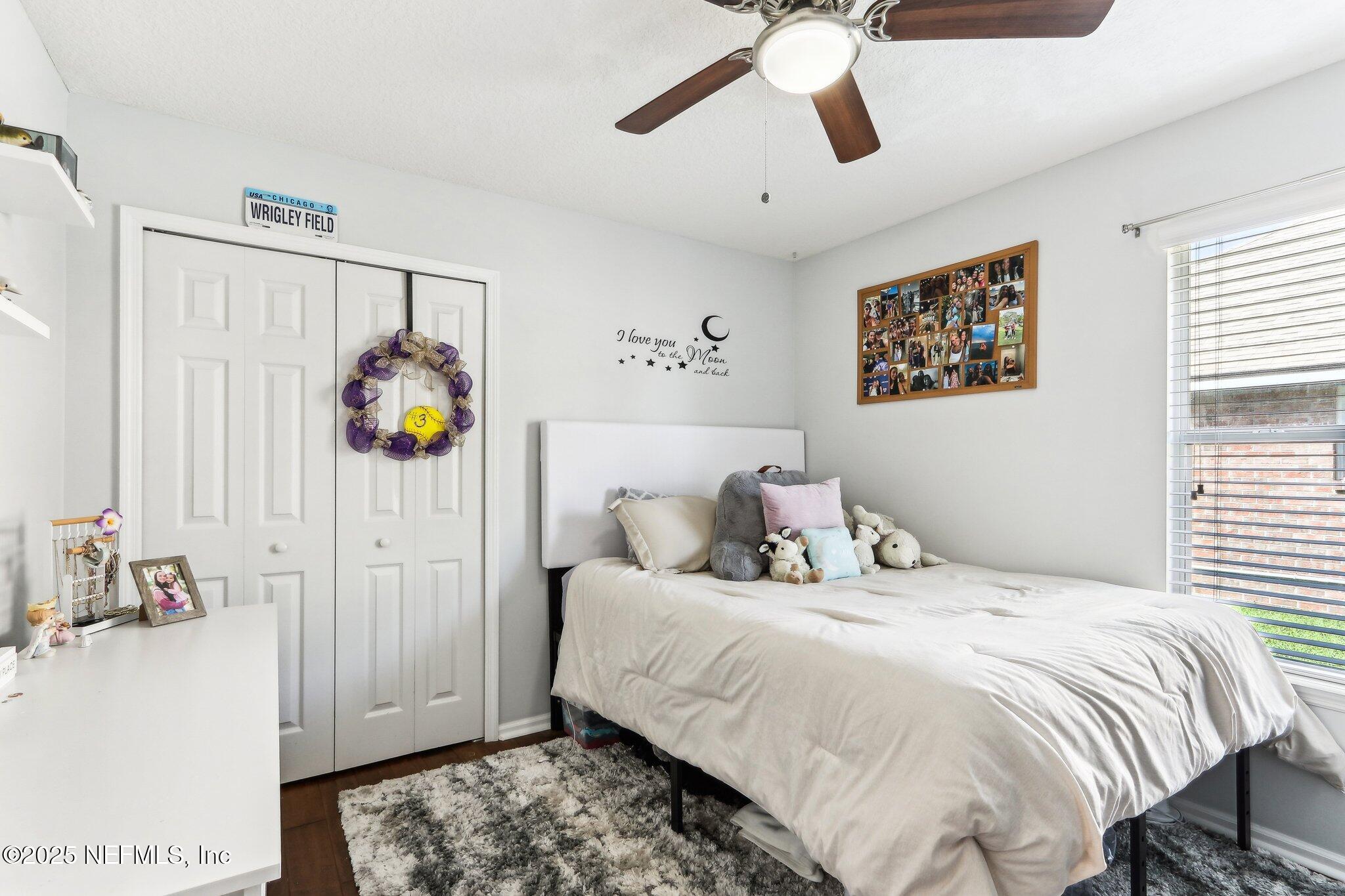 2124 Pond Spring Way Fleming Island, FL 32003 - Photo 22 of 56 a bedroom with a bed and a chandelier