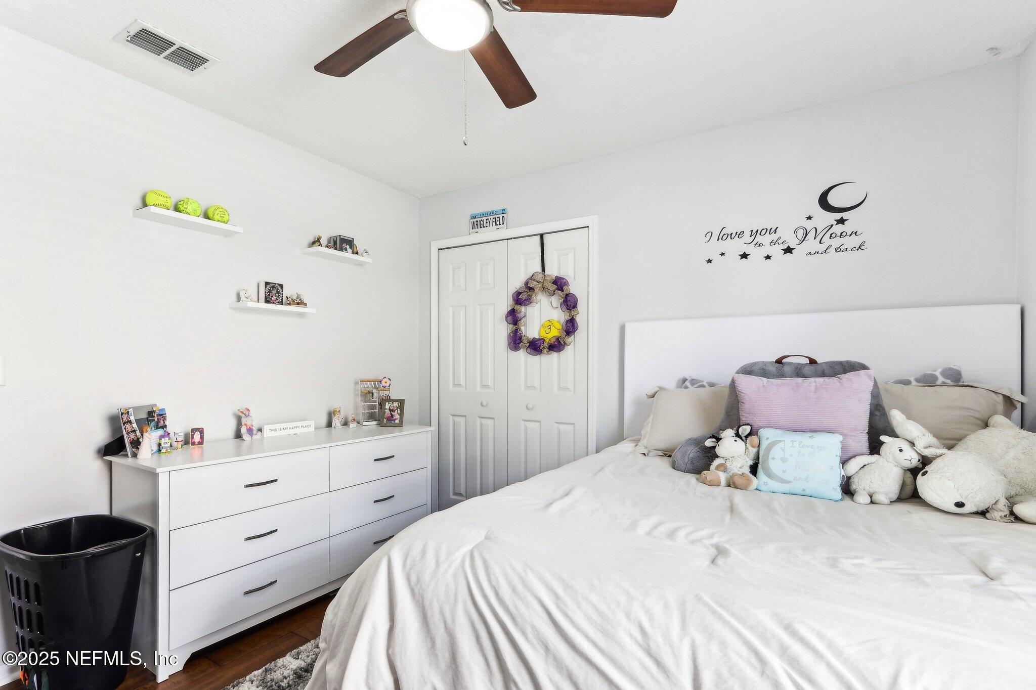 2124 Pond Spring Way Fleming Island, FL 32003 - Photo 24 of 56 a bedroom with a bed and a cabinets