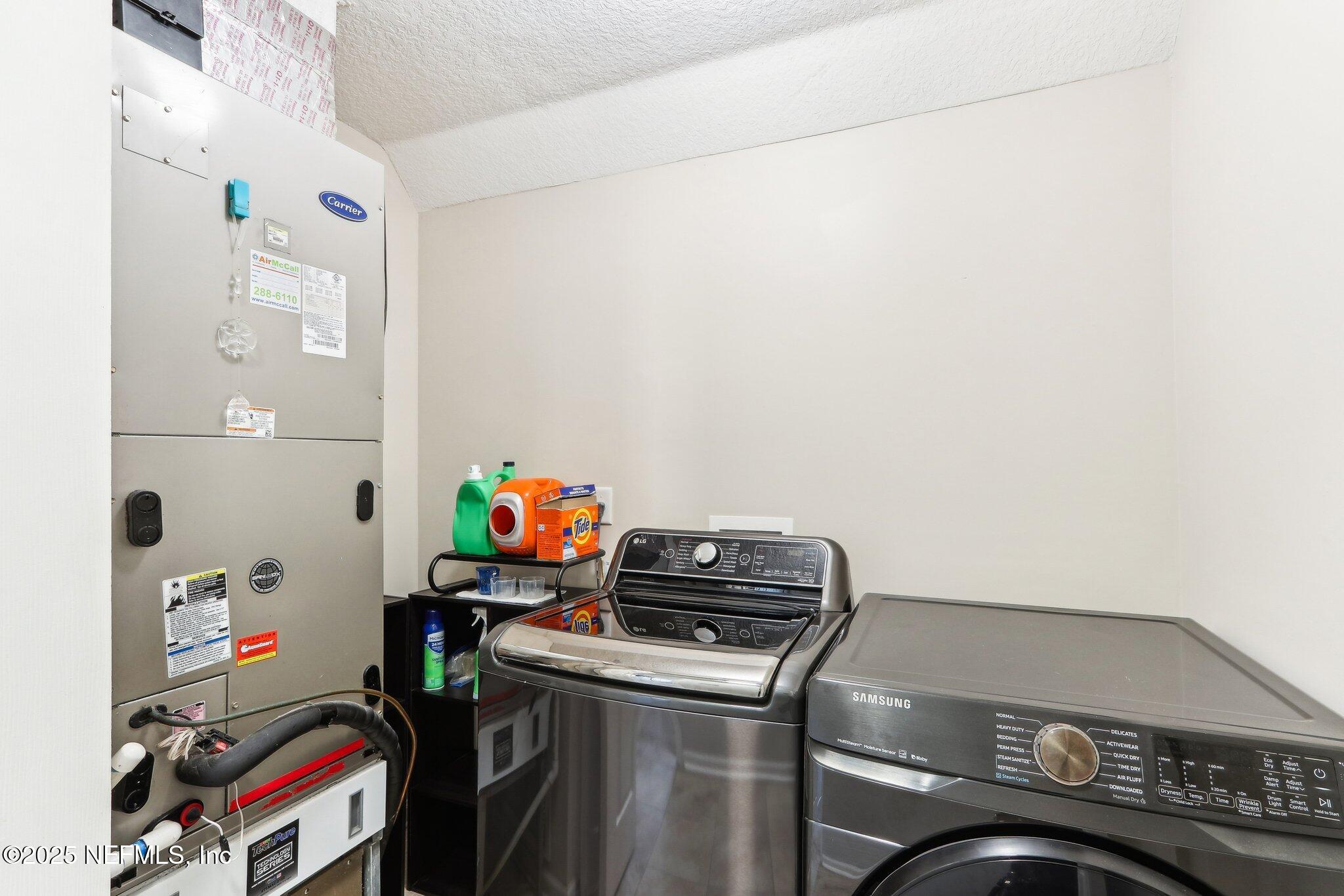 2124 Pond Spring Way Fleming Island, FL 32003 - Photo 29 of 56 a utility room with dryer and washer