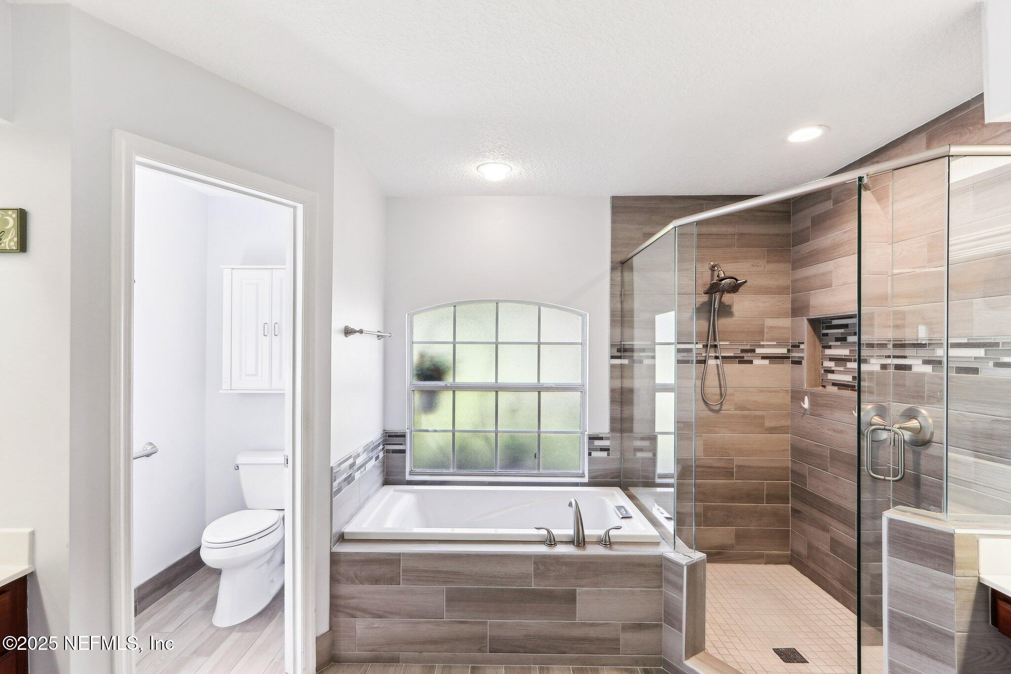 2124 Pond Spring Way Fleming Island, FL 32003 - Photo 33 of 56 a bathroom with a bathtub and a toilet