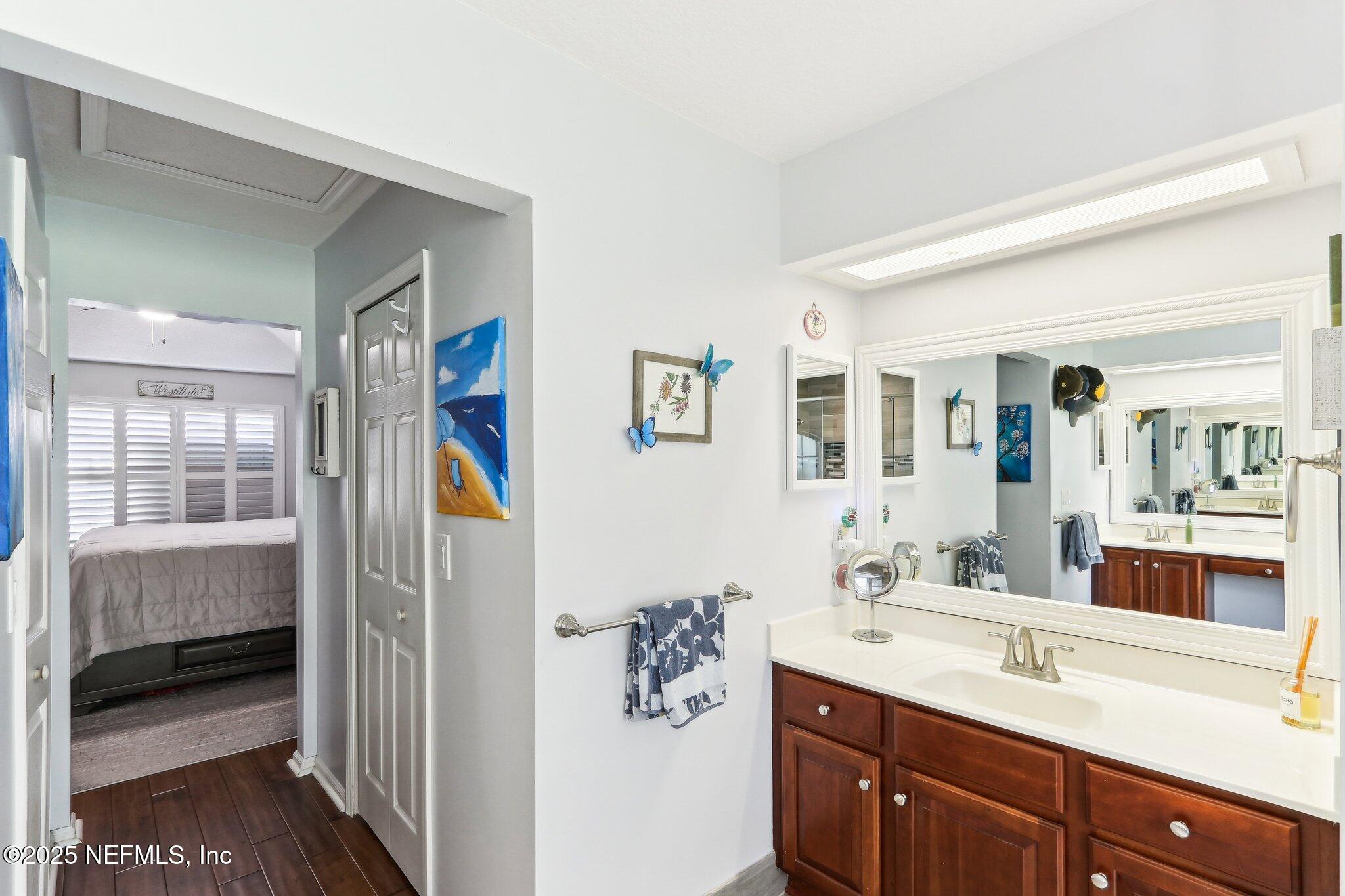 2124 Pond Spring Way Fleming Island, FL 32003 - Photo 35 of 56 a en suite bathroom with a double vanity sink and a mirror