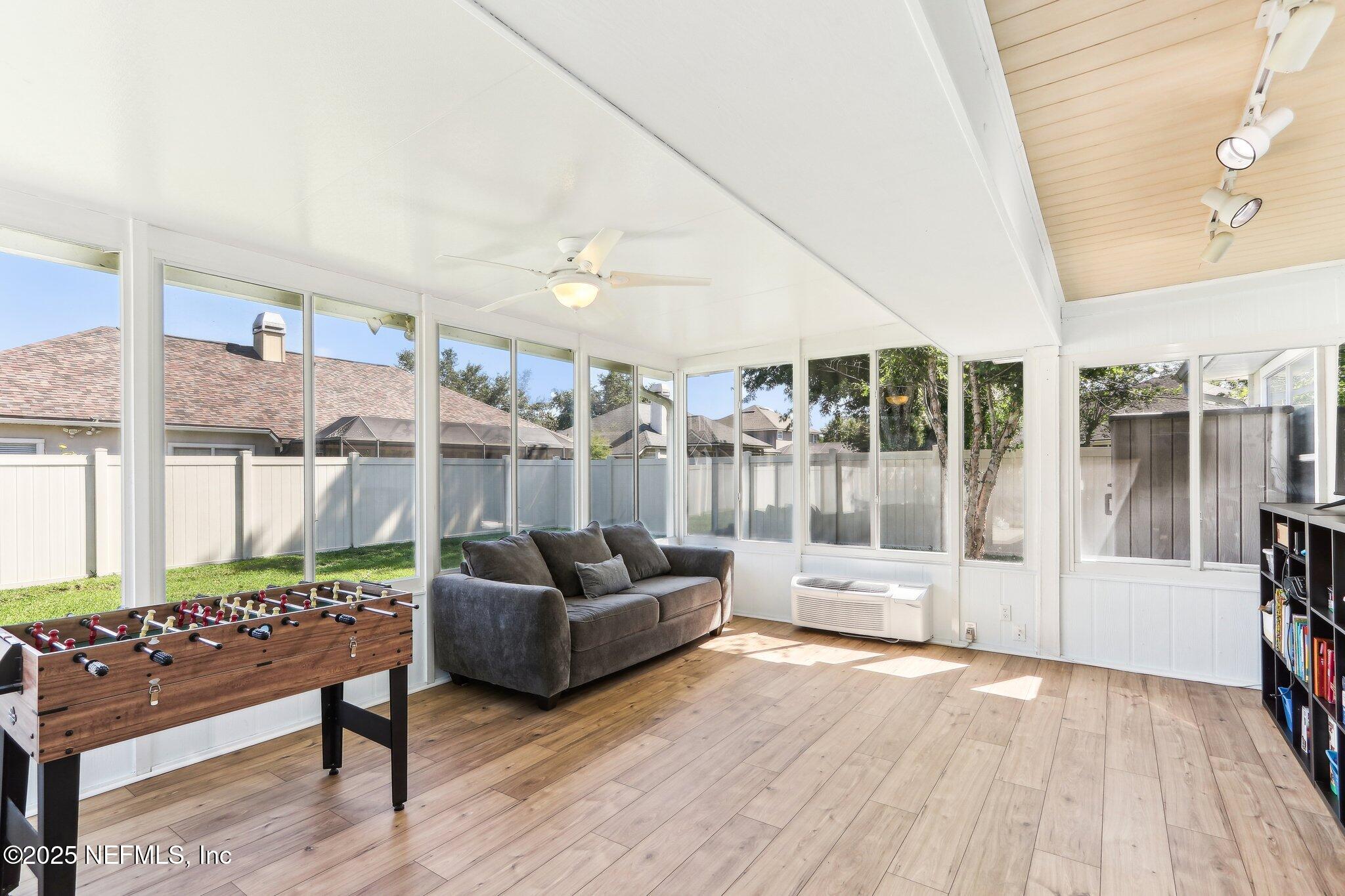 2124 Pond Spring Way Fleming Island, FL 32003 - Photo 36 of 56 a living room with furniture and a large window