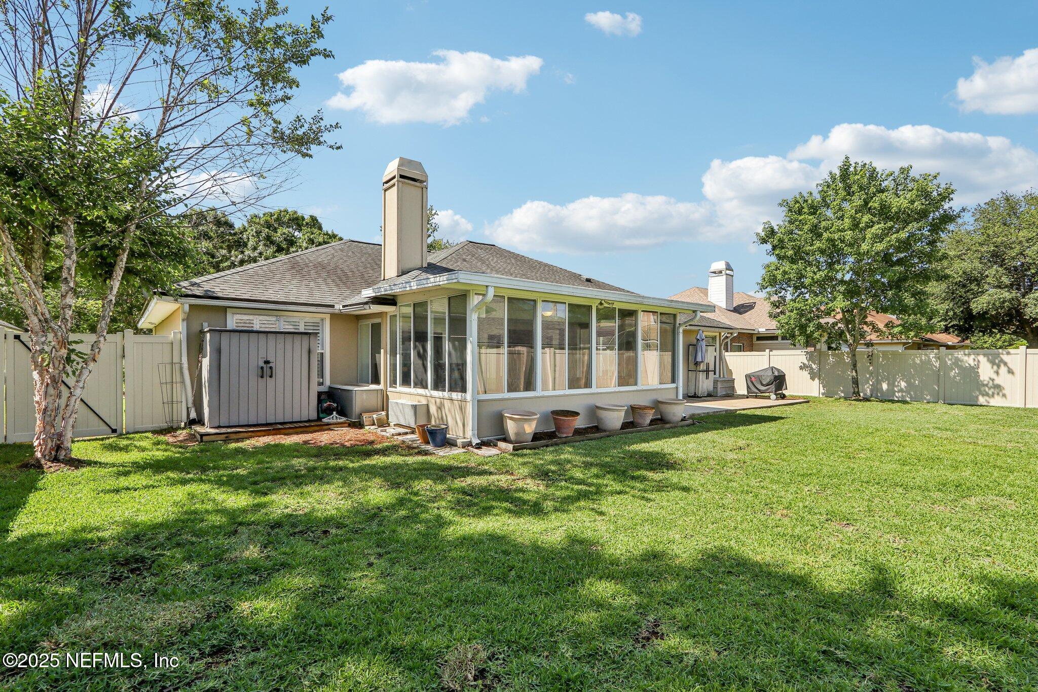 2124 Pond Spring Way Fleming Island, FL 32003 - Photo 41 of 56 a view of a house with a yard and sitting area