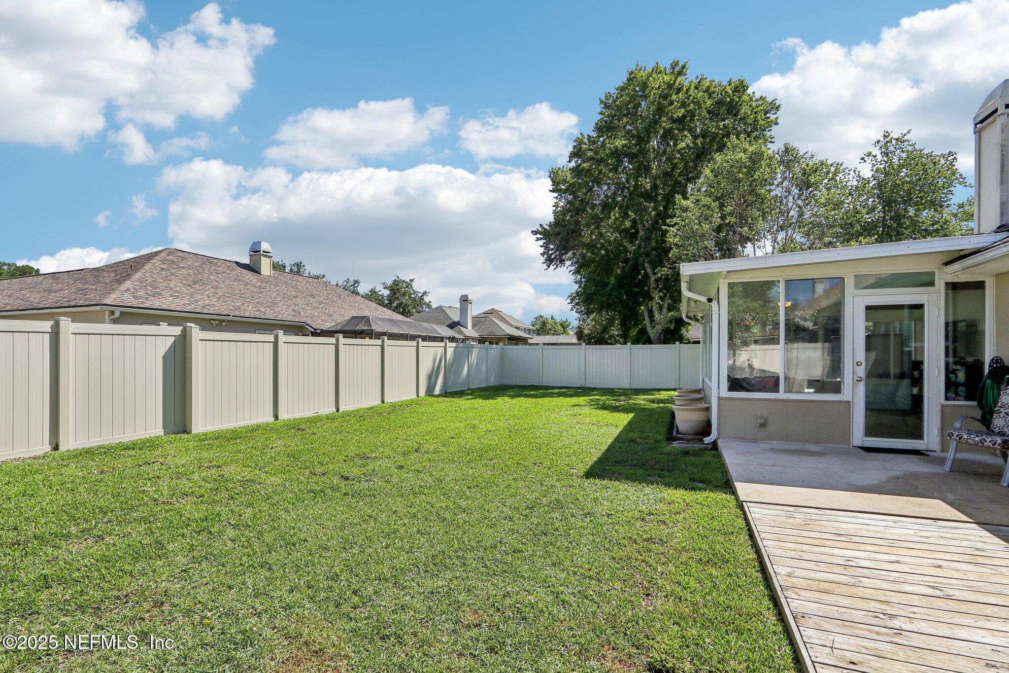 2124 Pond Spring Way Fleming Island, FL 32003 - Photo 42 of 56 a view of a house with backyard and porch