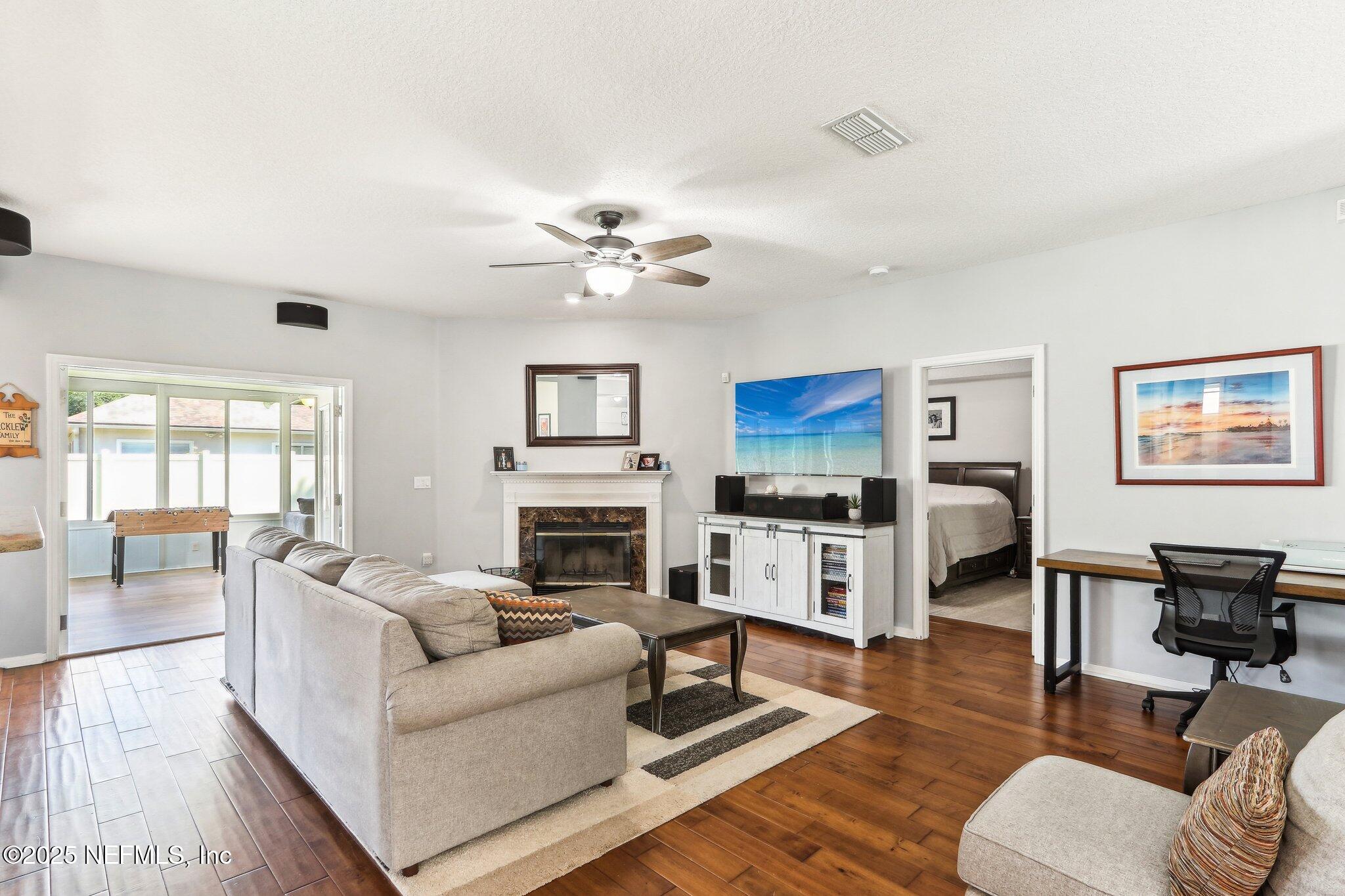 2124 Pond Spring Way Fleming Island, FL 32003 - Photo 9 of 56 a living room with furniture fireplace and a window
