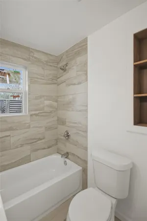 a bathroom with a toilet and a bathtub
