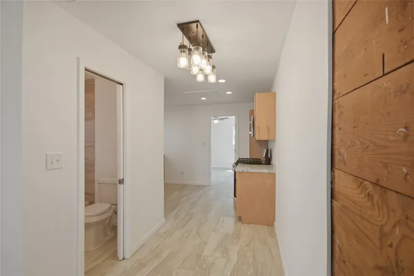 a view of a hallway view with wooden floor and staircase