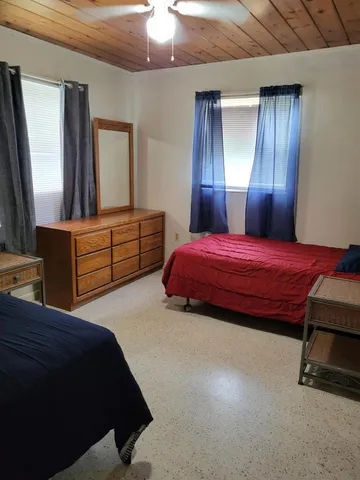 a bedroom with a bed and a dresser