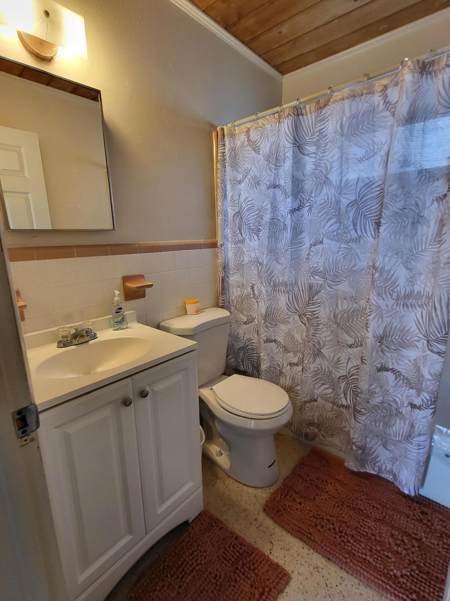 1169 Seaway Drive, Unit A Fort Pierce, FL 34949 - Photo 12 of 13 a bathroom with a sink and a toilet
