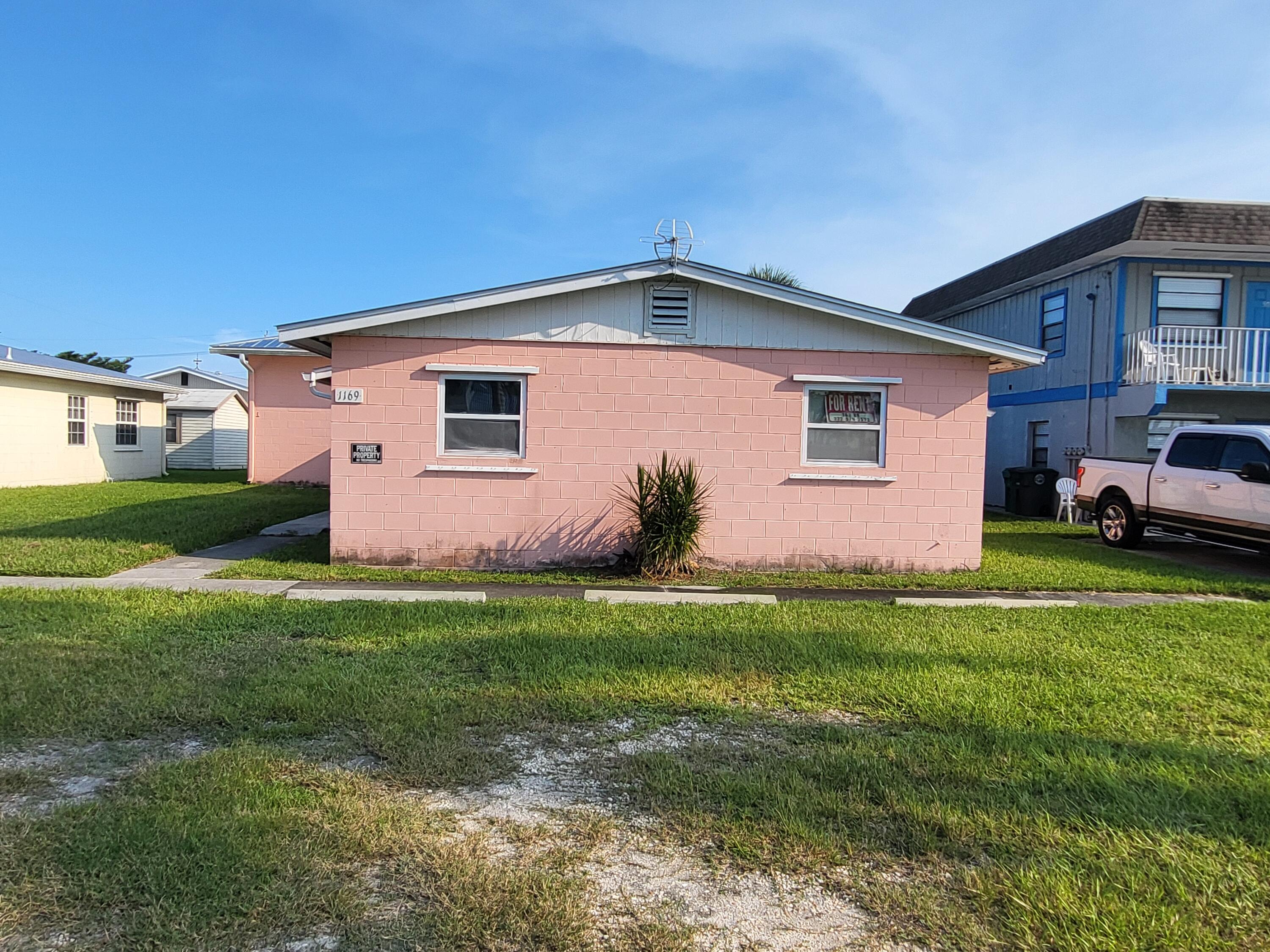 1169 Seaway Drive, Unit A Fort Pierce, FL 34949 - Photo 2 of 13 a front view of house with yard