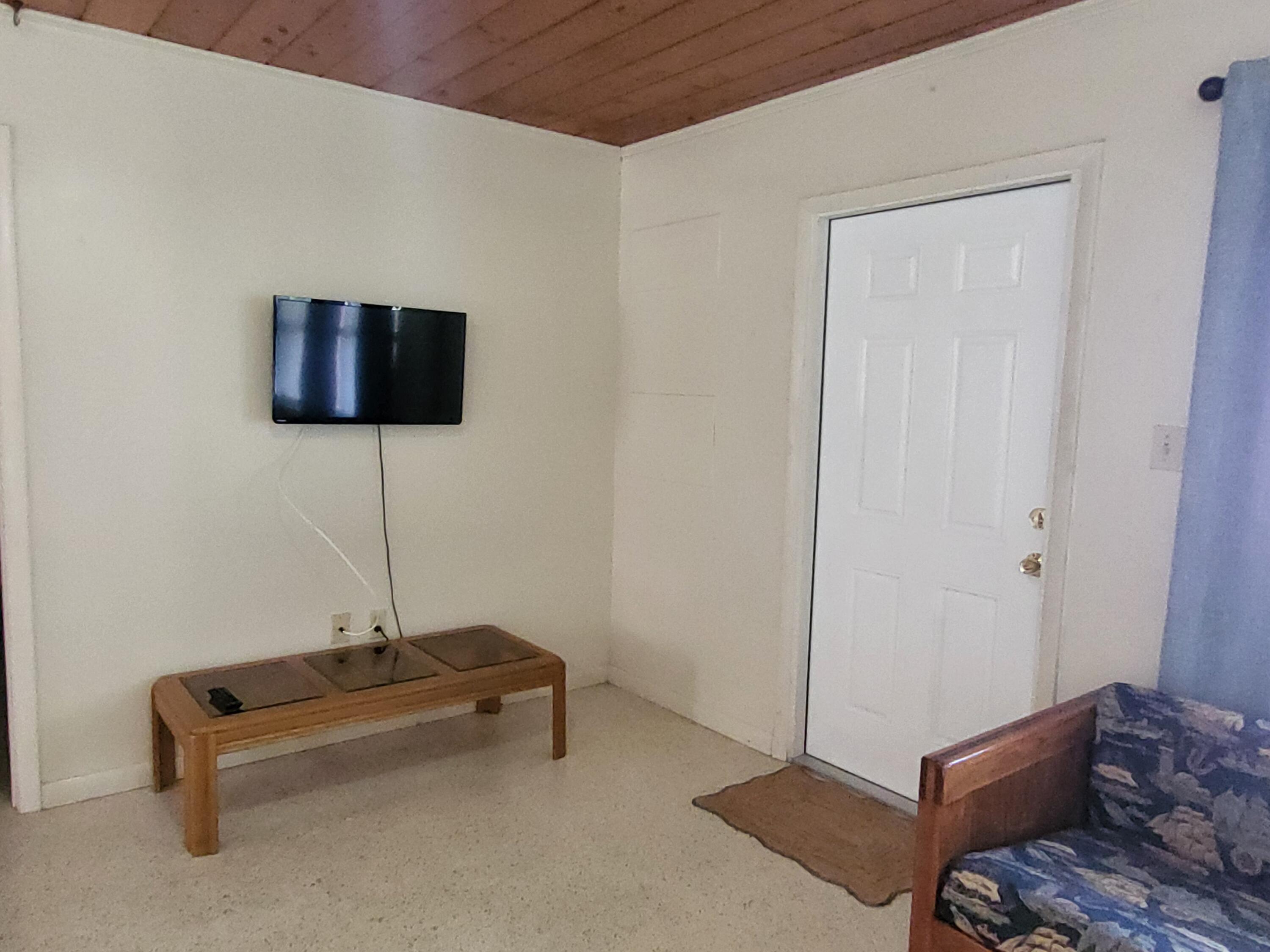 1169 Seaway Drive, Unit A Fort Pierce, FL 34949 - Photo 3 of 13 a living room with furniture and a flat screen tv