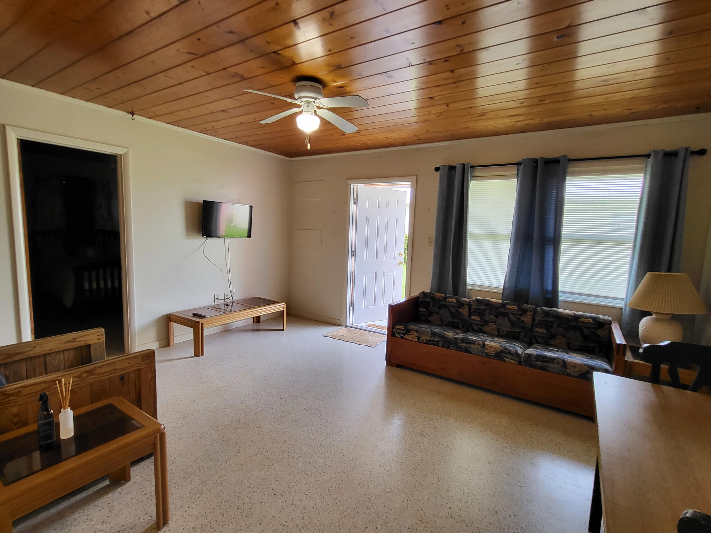 1169 Seaway Drive, Unit A Fort Pierce, FL 34949 - Photo 7 of 13 a living room with furniture and a flat screen tv