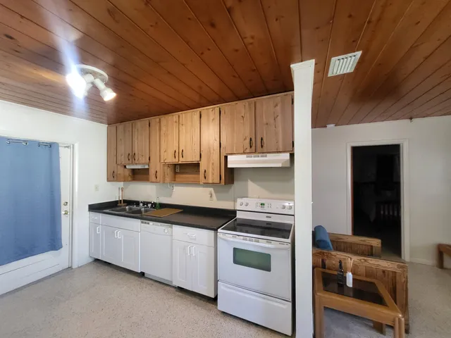 a kitchen with stainless steel appliances granite countertop a sink and cabinets