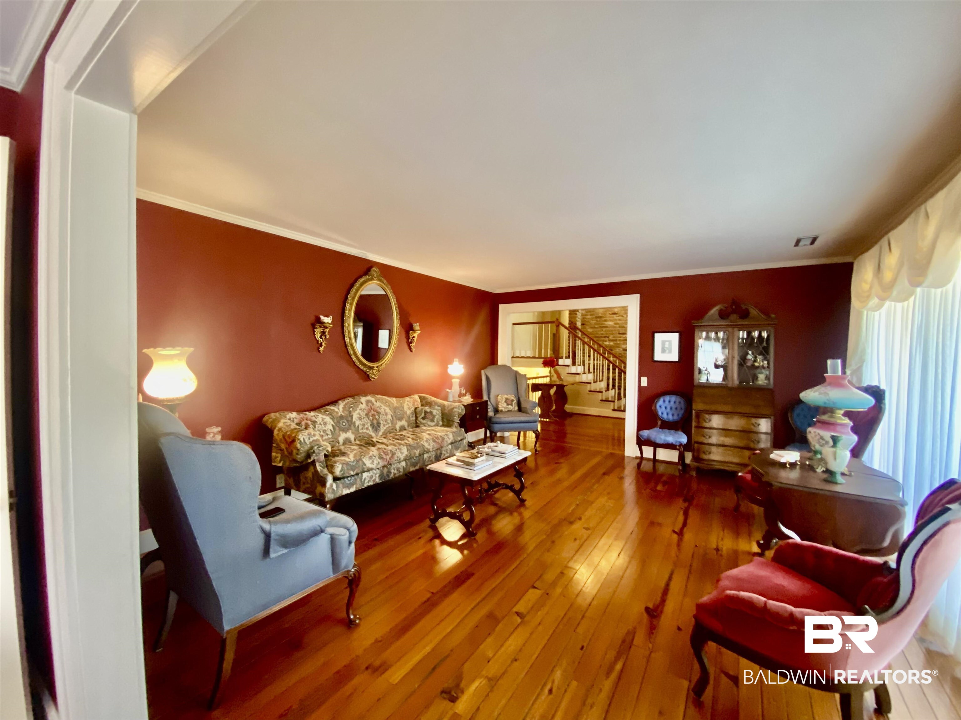 Living room featuring hardwood / wood-style flooring and crown molding.