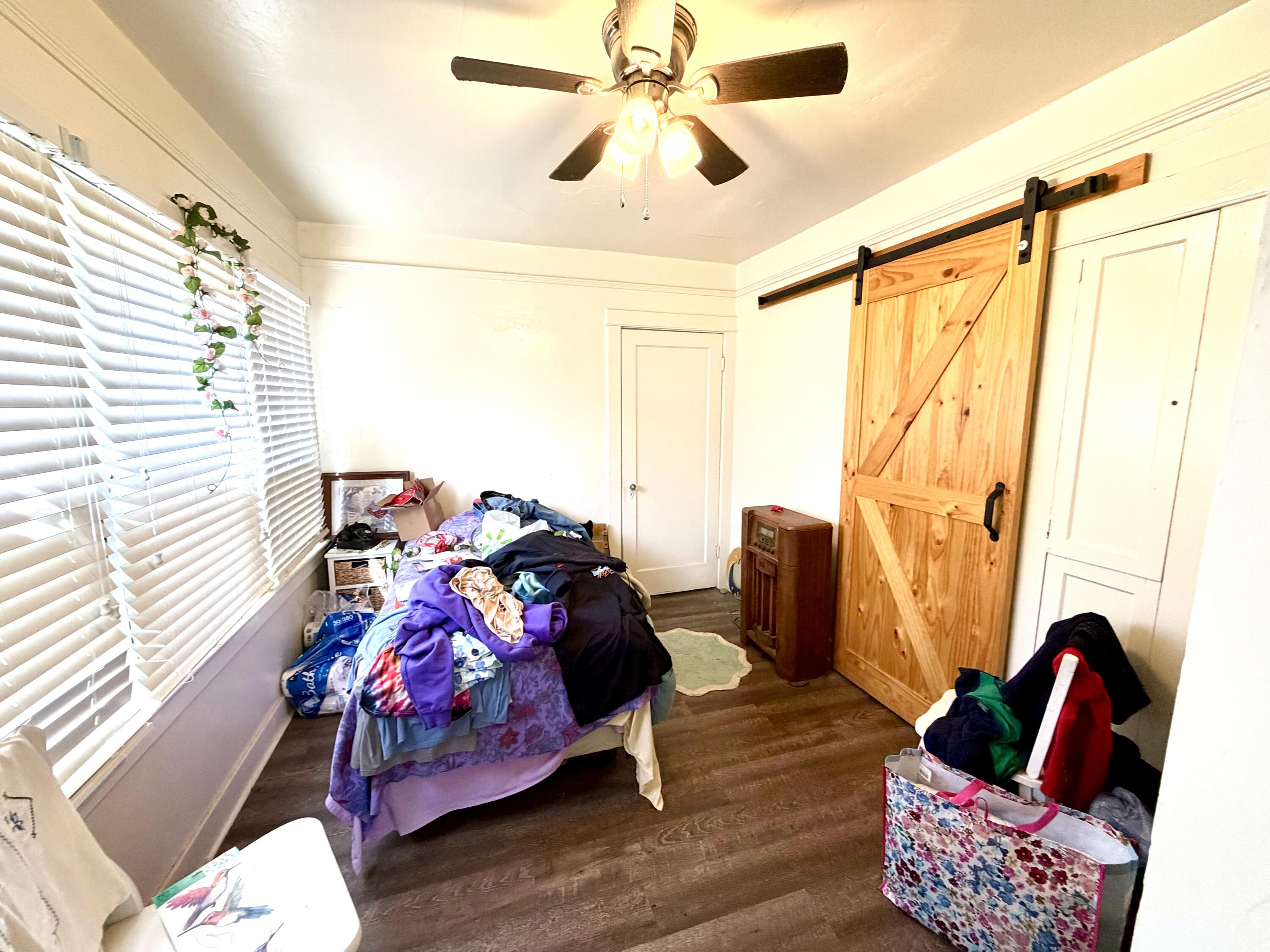 200 North B Street Exeter, CA 93221 - Photo 15 of 20 a bedroom with furniture and a window