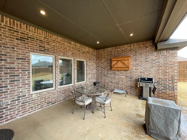 a patio with patio couch and chairs