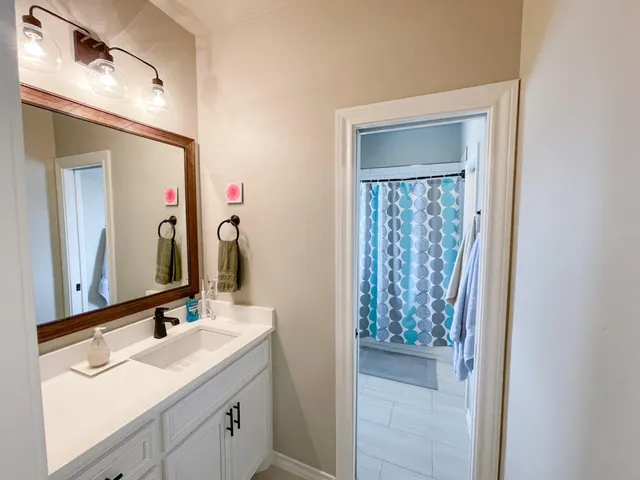 a bathroom with a double vanity sink and a mirror