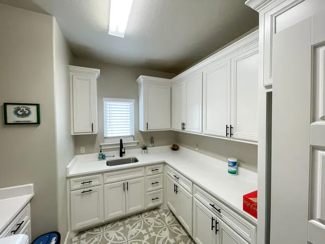 a room with sink cabinets and window
