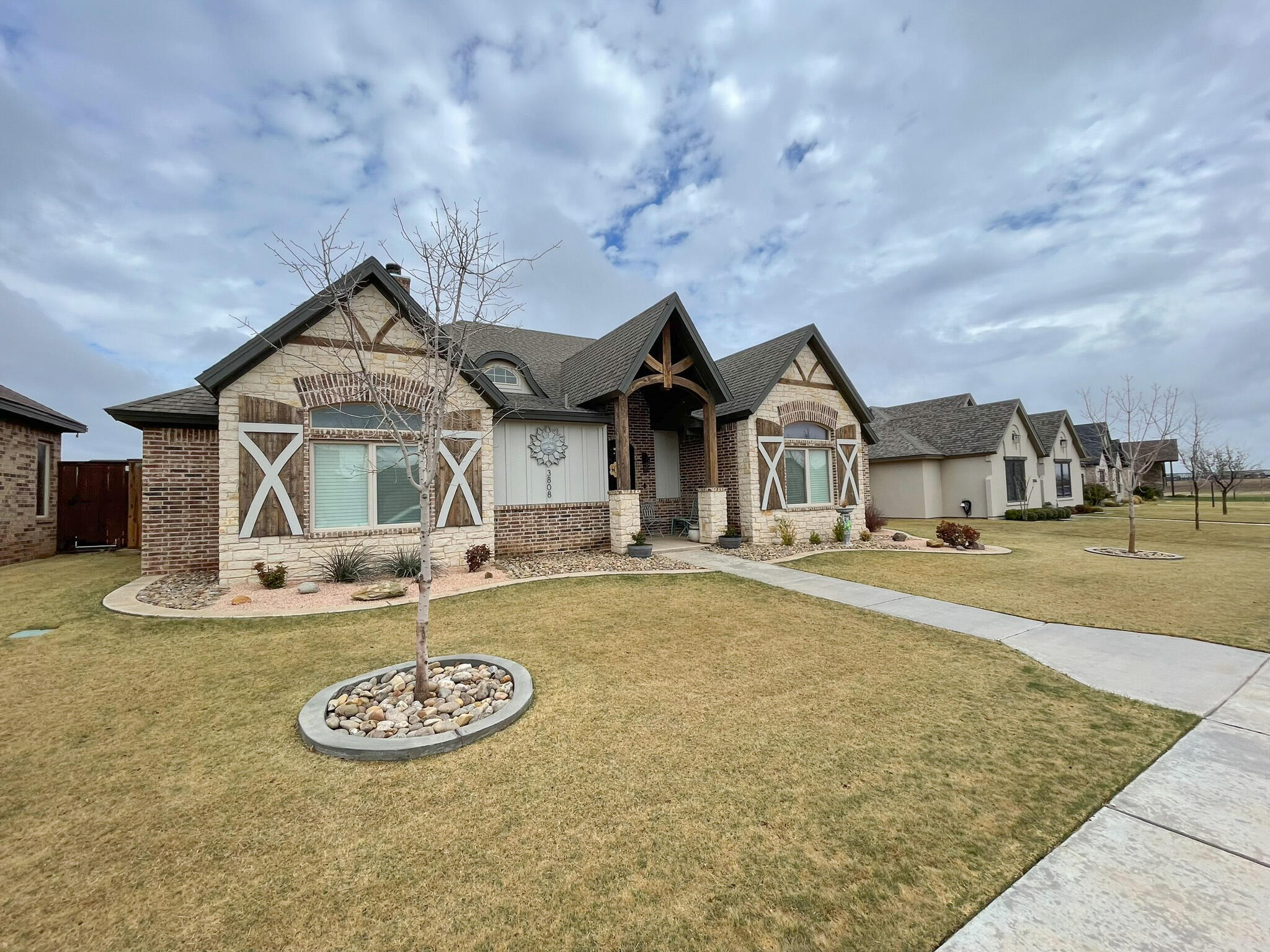 3808 138th Street Lubbock, TX 79423 - Photo 2 of 17 a front view of a house with garden