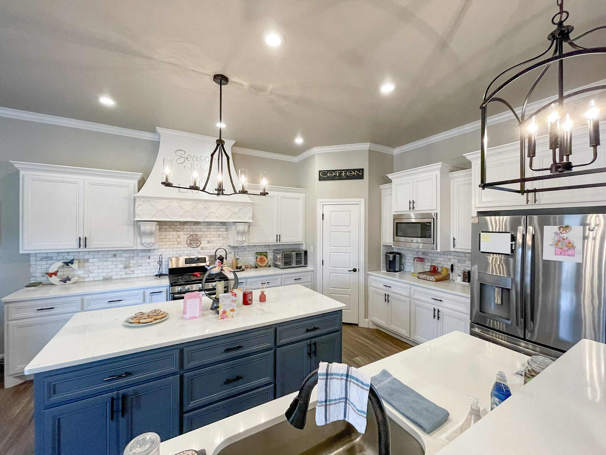 3808 138th Street Lubbock, TX 79423 - Photo 5 of 17 a kitchen with a sink a stove a refrigerator and cabinets