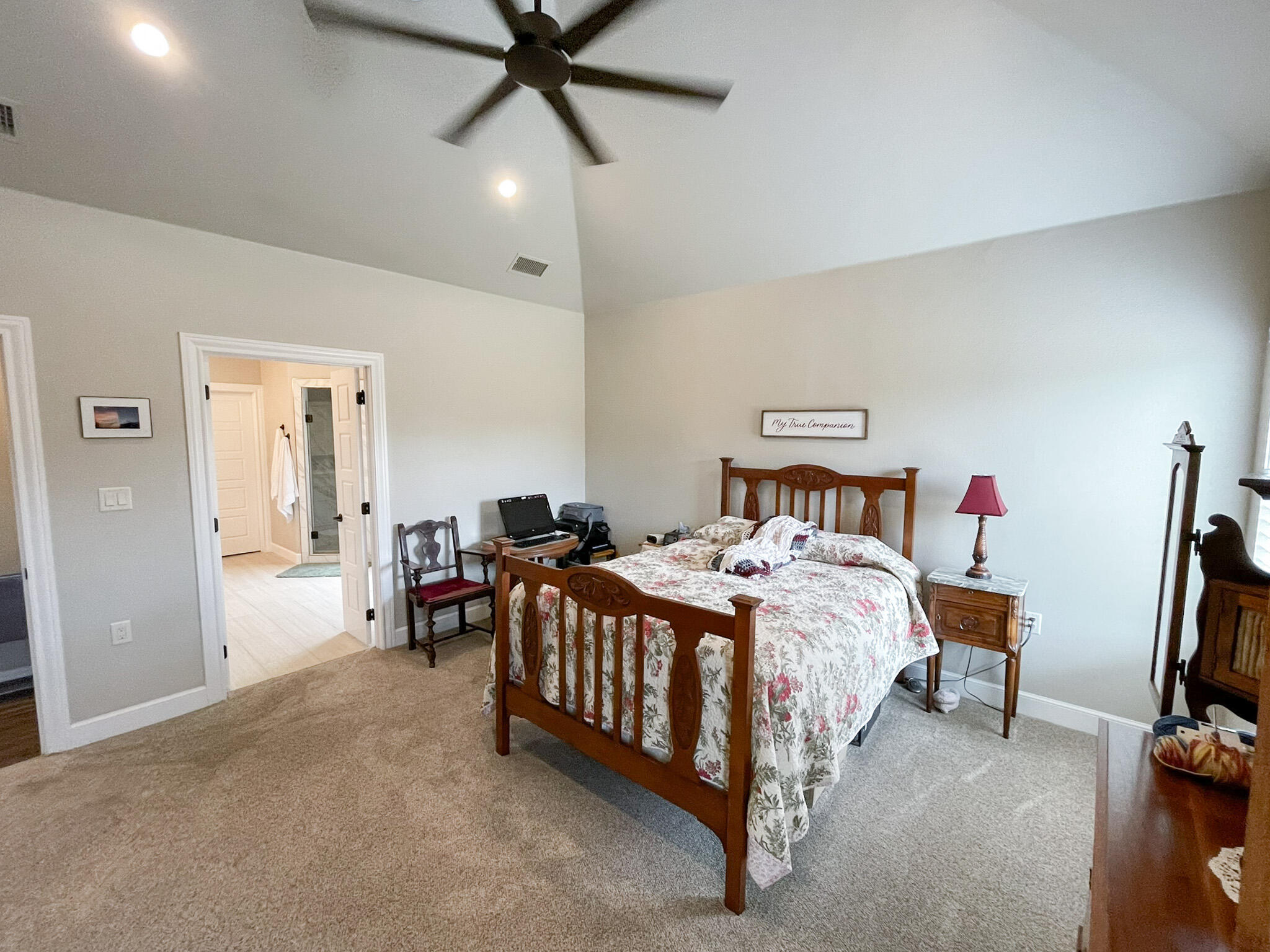 3808 138th Street Lubbock, TX 79423 - Photo 7 of 17 a bed room with a bed and a chandelier