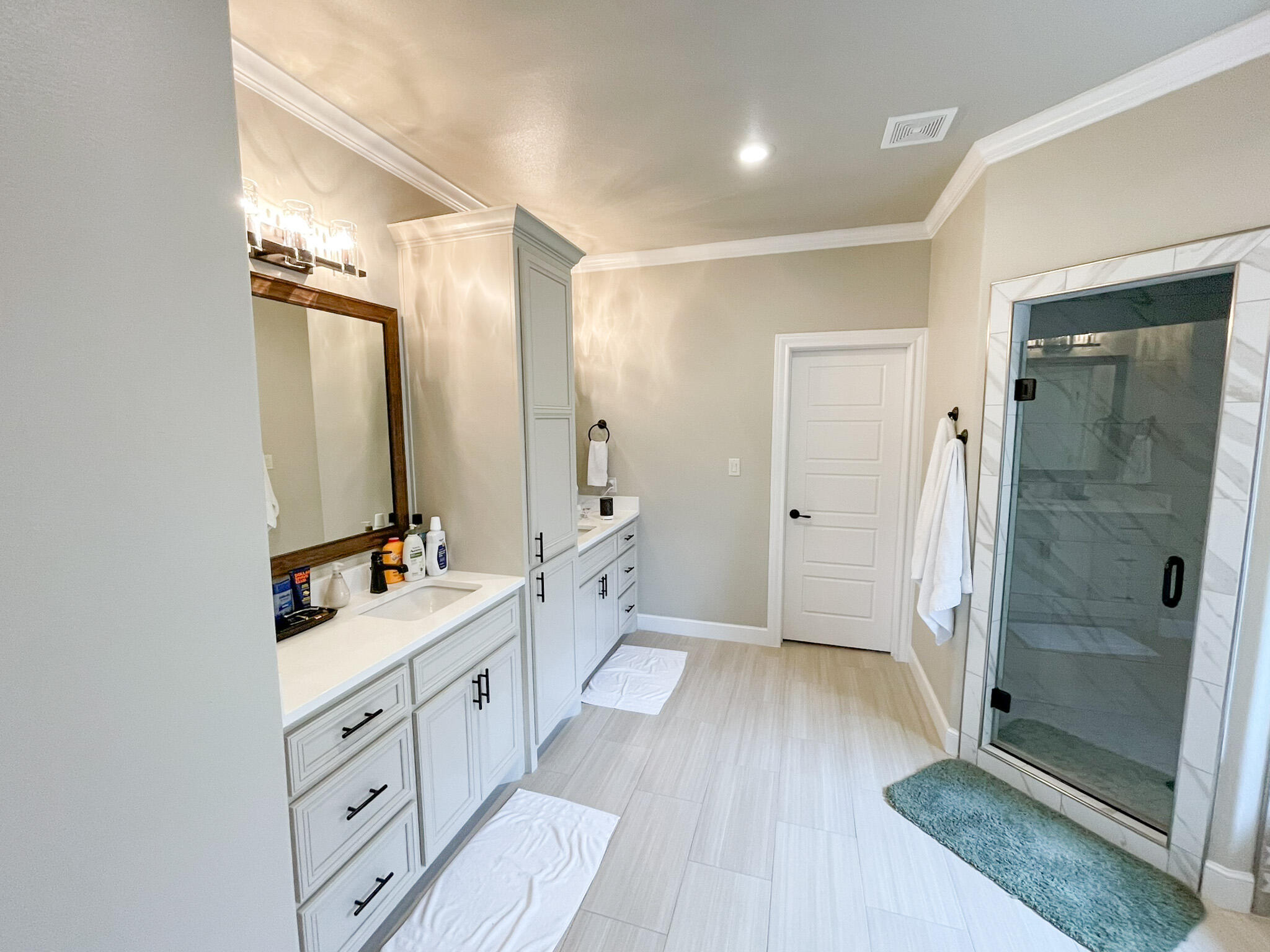3808 138th Street Lubbock, TX 79423 - Photo 8 of 17 a spacious bathroom with a double vanity sink a mirror and a shower