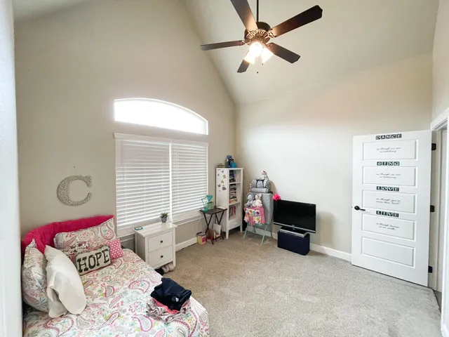 a bedroom with furniture and a window