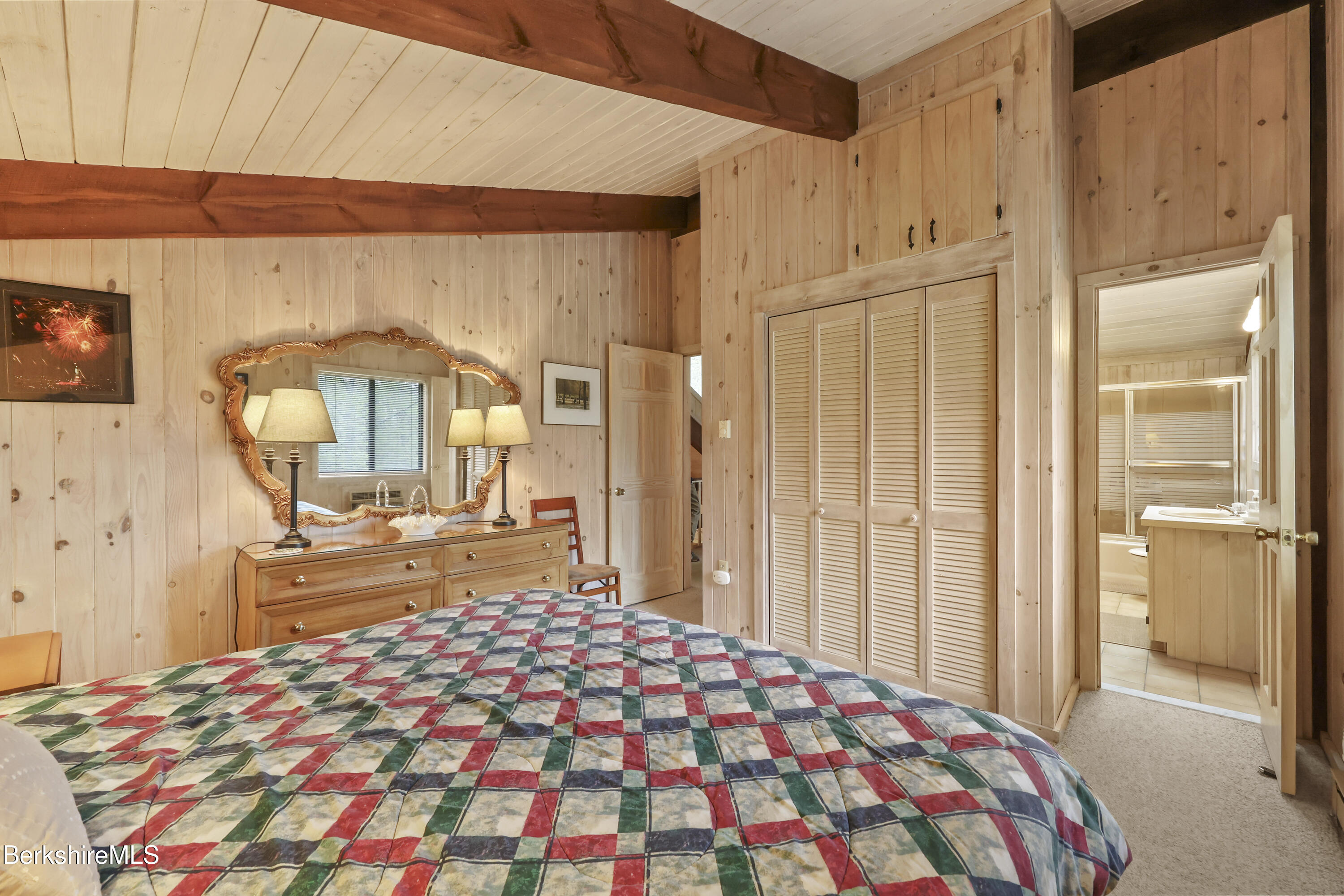 422 Bonny Rigg Hill Road Becket, MA 01223 - Photo 38 of 60 a bedroom with a bed and a large mirror on the dresser
