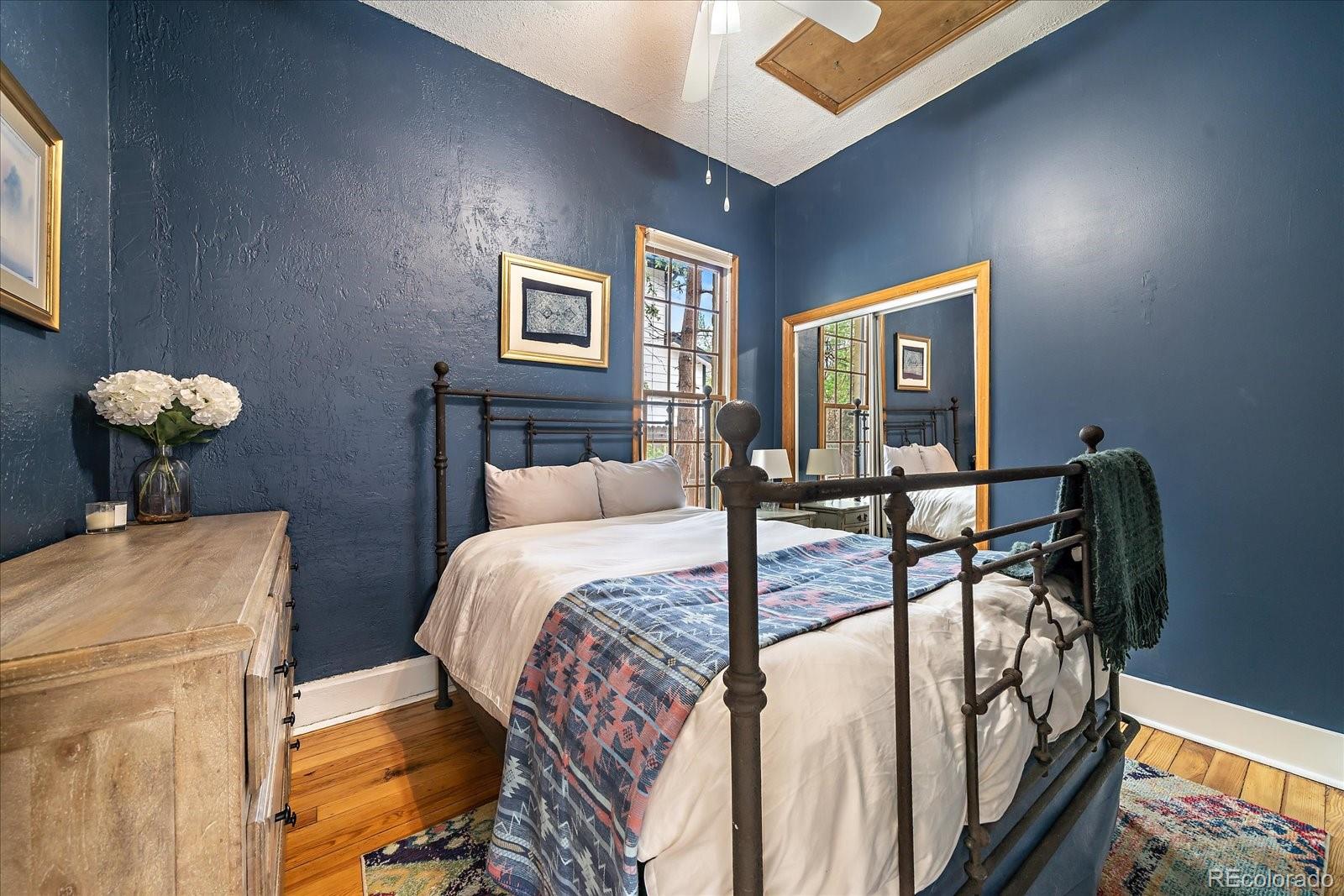 1776 South Logan Street Denver, CO 80210 - Photo 13 of 21 a bedroom with a bed table and chair