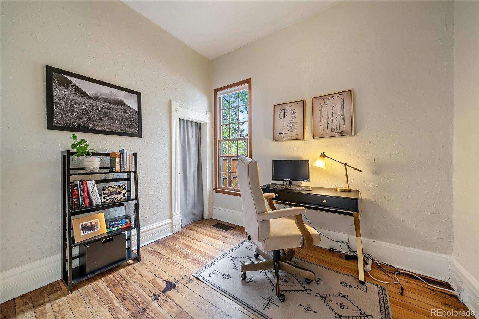 1776 South Logan Street Denver, CO 80210 - Photo 15 of 21 a view of a workspace with furniture and wooden floor
