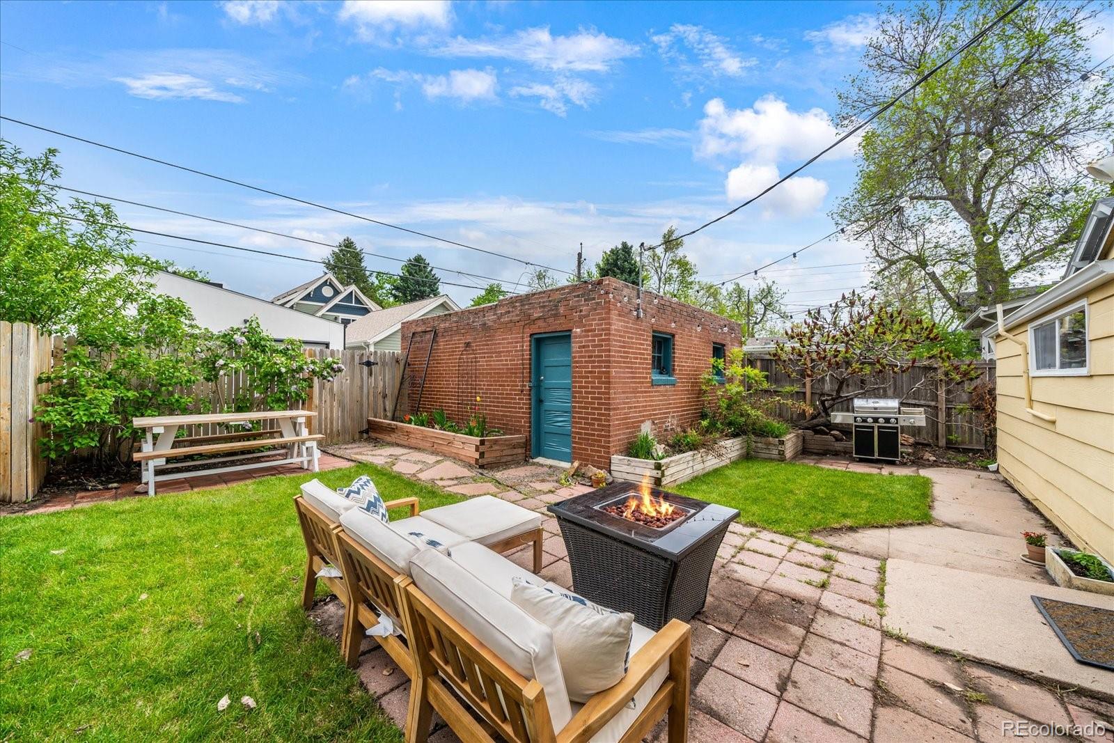 1776 South Logan Street Denver, CO 80210 - Photo 16 of 21 a view of a patio with table and chairs with wooden fence and plants