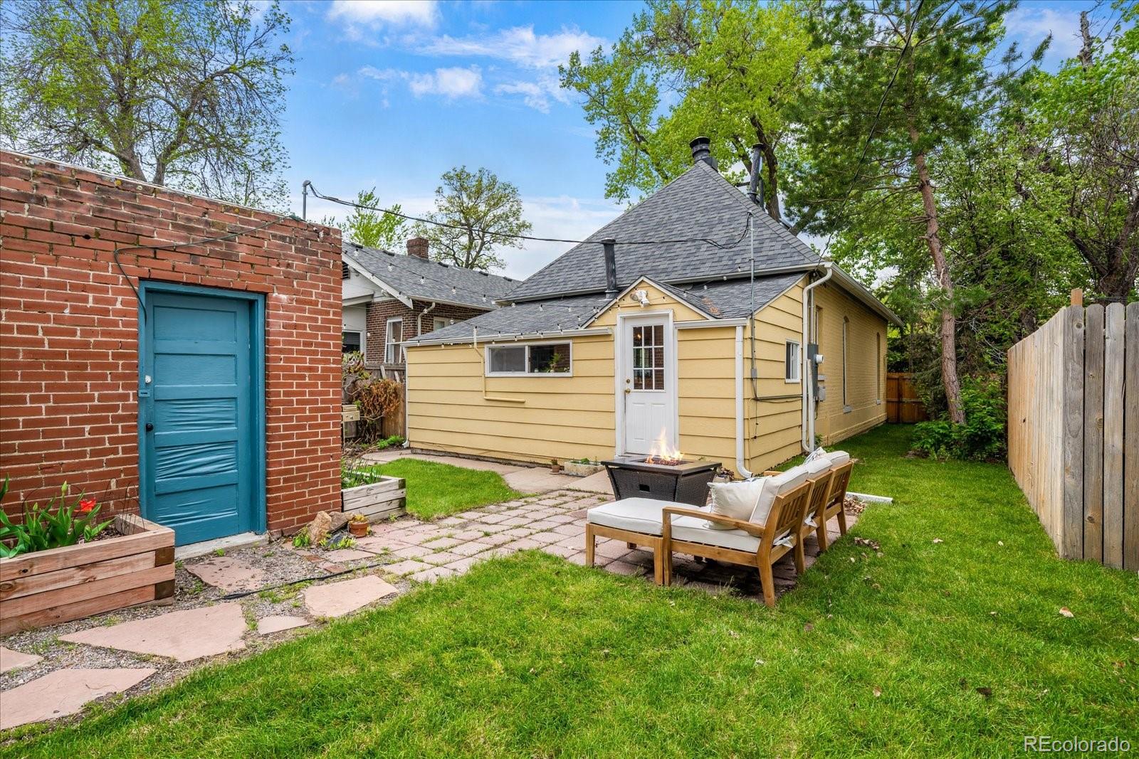 1776 South Logan Street Denver, CO 80210 - Photo 17 of 21 a backyard of a house with table and chairs