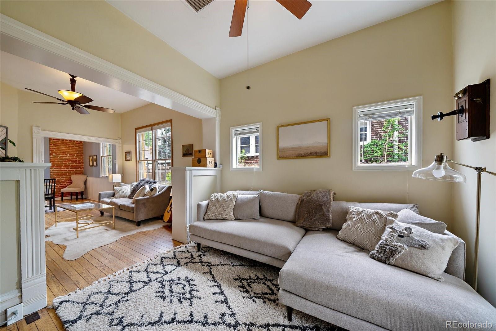 1776 South Logan Street Denver, CO 80210 - Photo 3 of 21 a living room with furniture and a couch