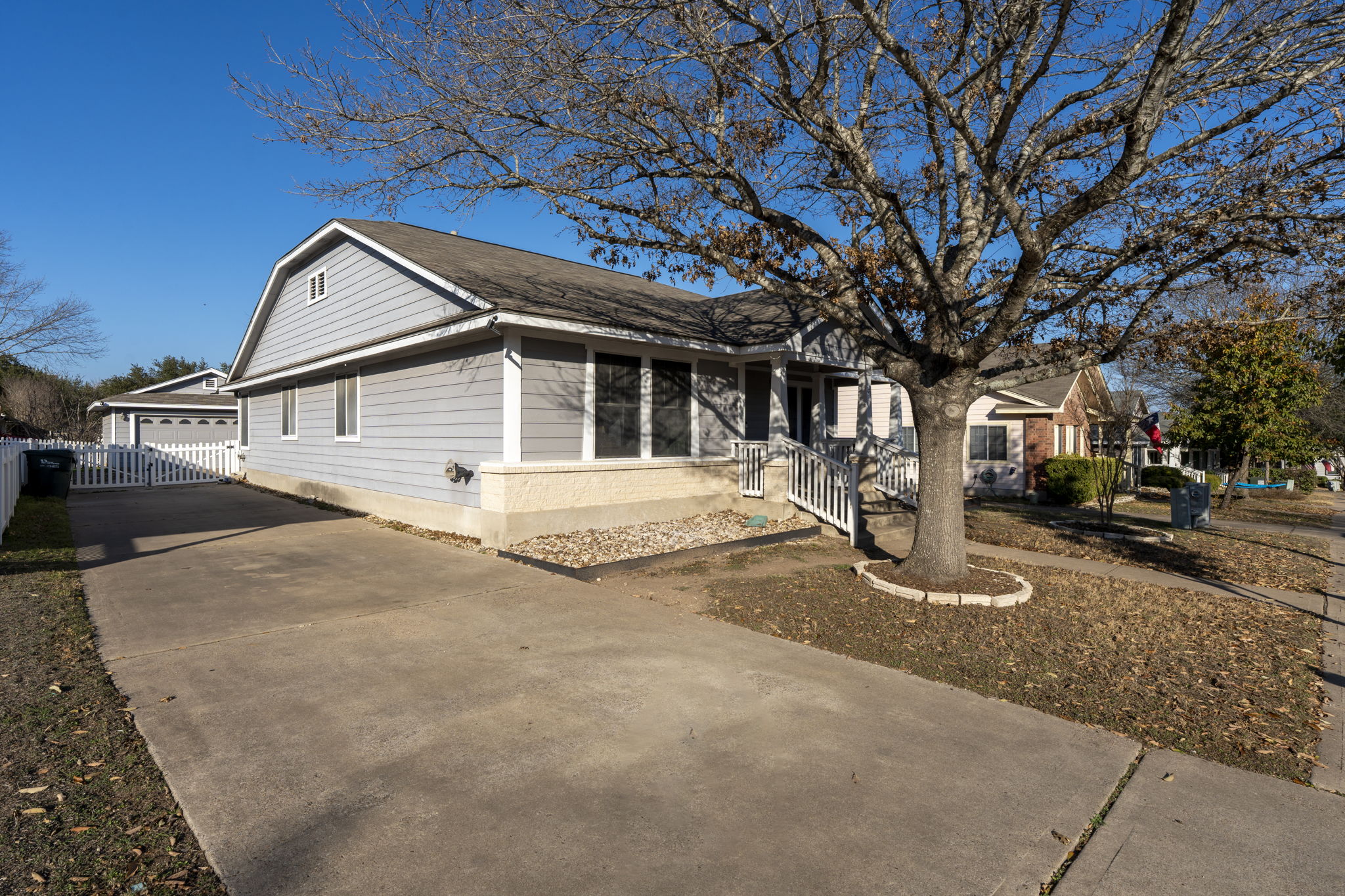175 Wetzel Kyle, TX 78640 - Photo 2 of 40 Front exterior of the home with view of long driveway down the side of the home.